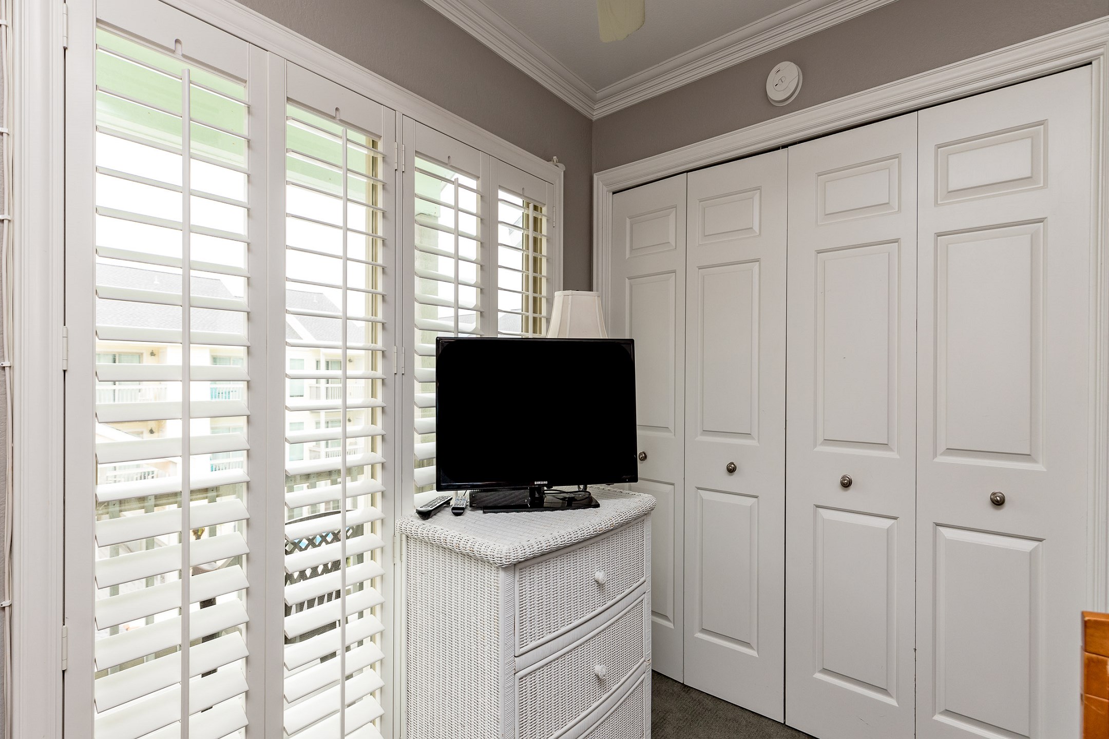 Second bedroom on the second floor with two sets of twin size bunk beds and a crib (sheets not provided for crib), along with flat screen TV and private balcony 