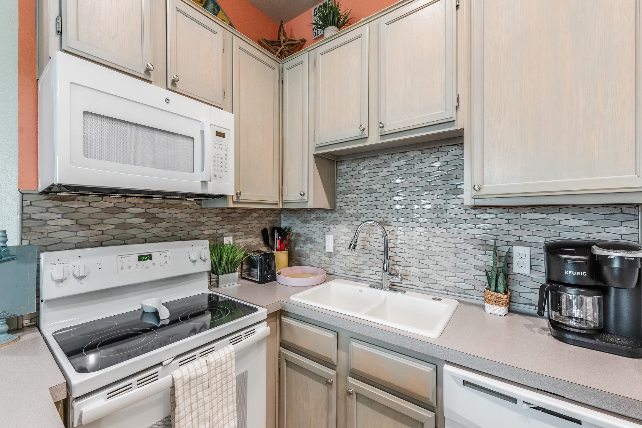 Compact kitchen space with coffee maker, toaster, cookware, dinnerware, and other kitchen essentials provided