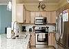 Fully equipped kitchen with stainless steel appliances and ample storage space