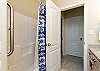 Guest bathroom on the second floor with double sinks and tub/shower combo 