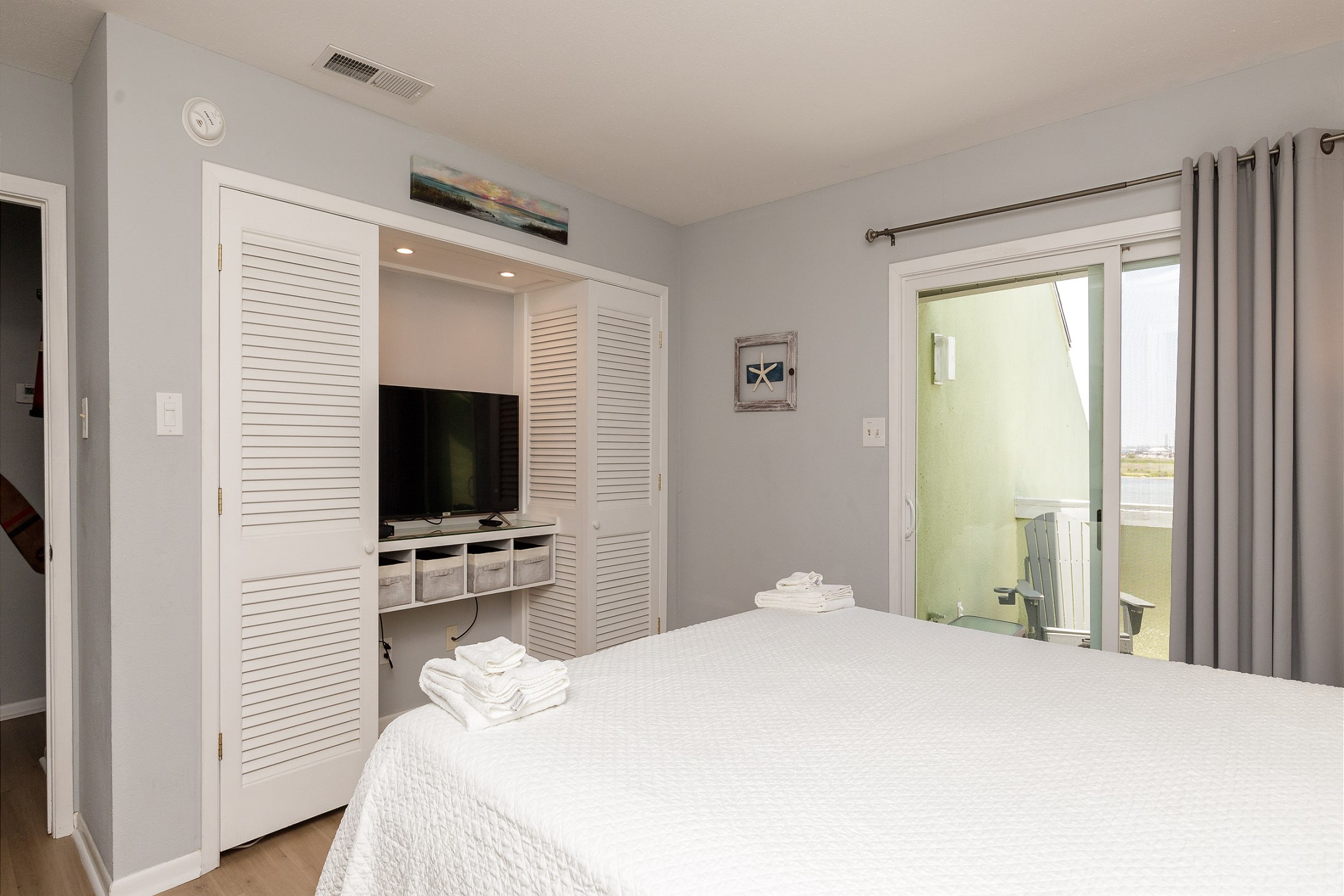 Master bedroom with king size bed and Tempur-Pedic memory foam mattress topper, along with 4K HDR Smart TV and ensuite bathroom