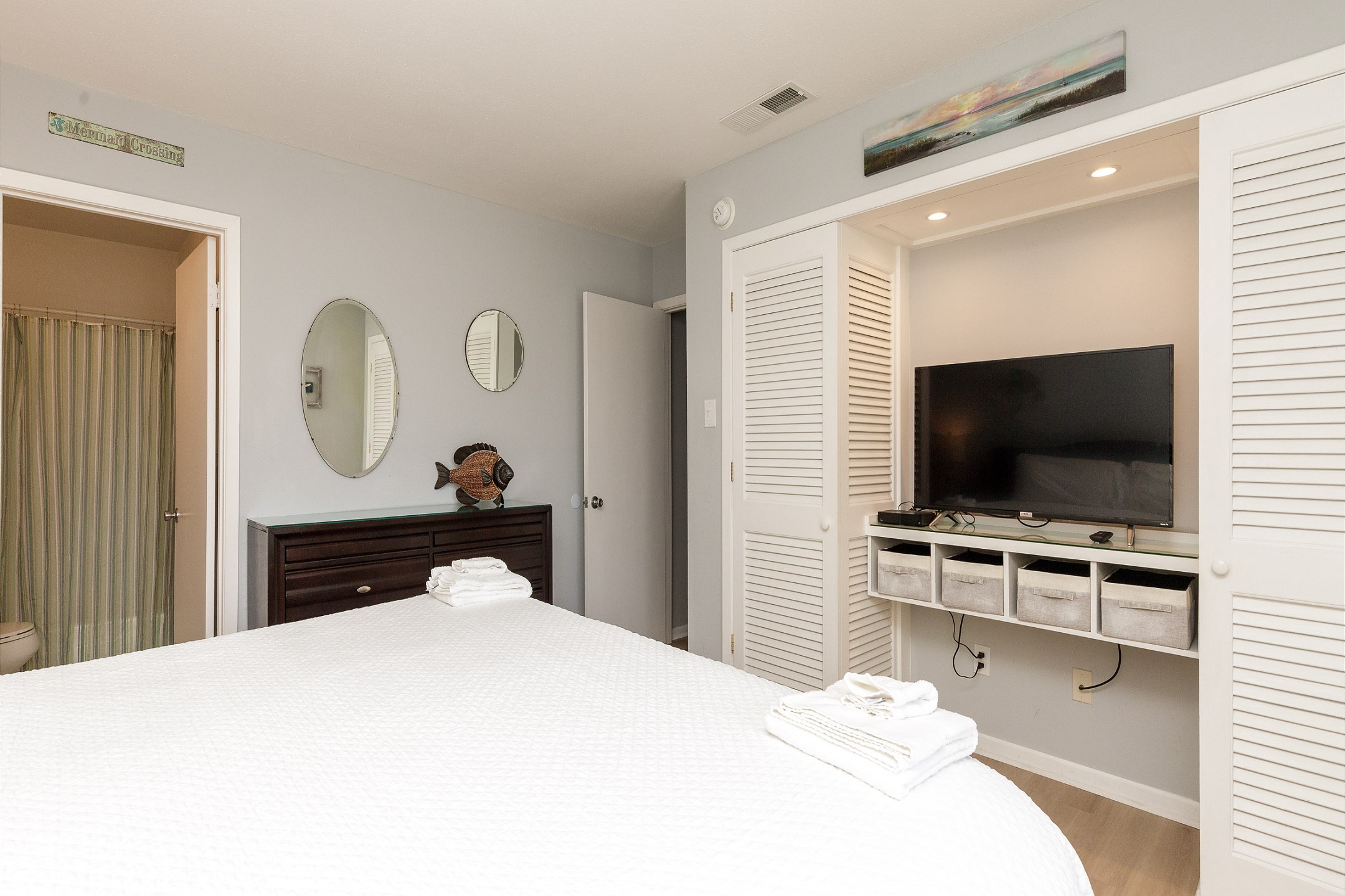 Master bedroom with king size bed and Tempur-Pedic memory foam mattress topper, along with 4K HDR Smart TV and ensuite bathroom