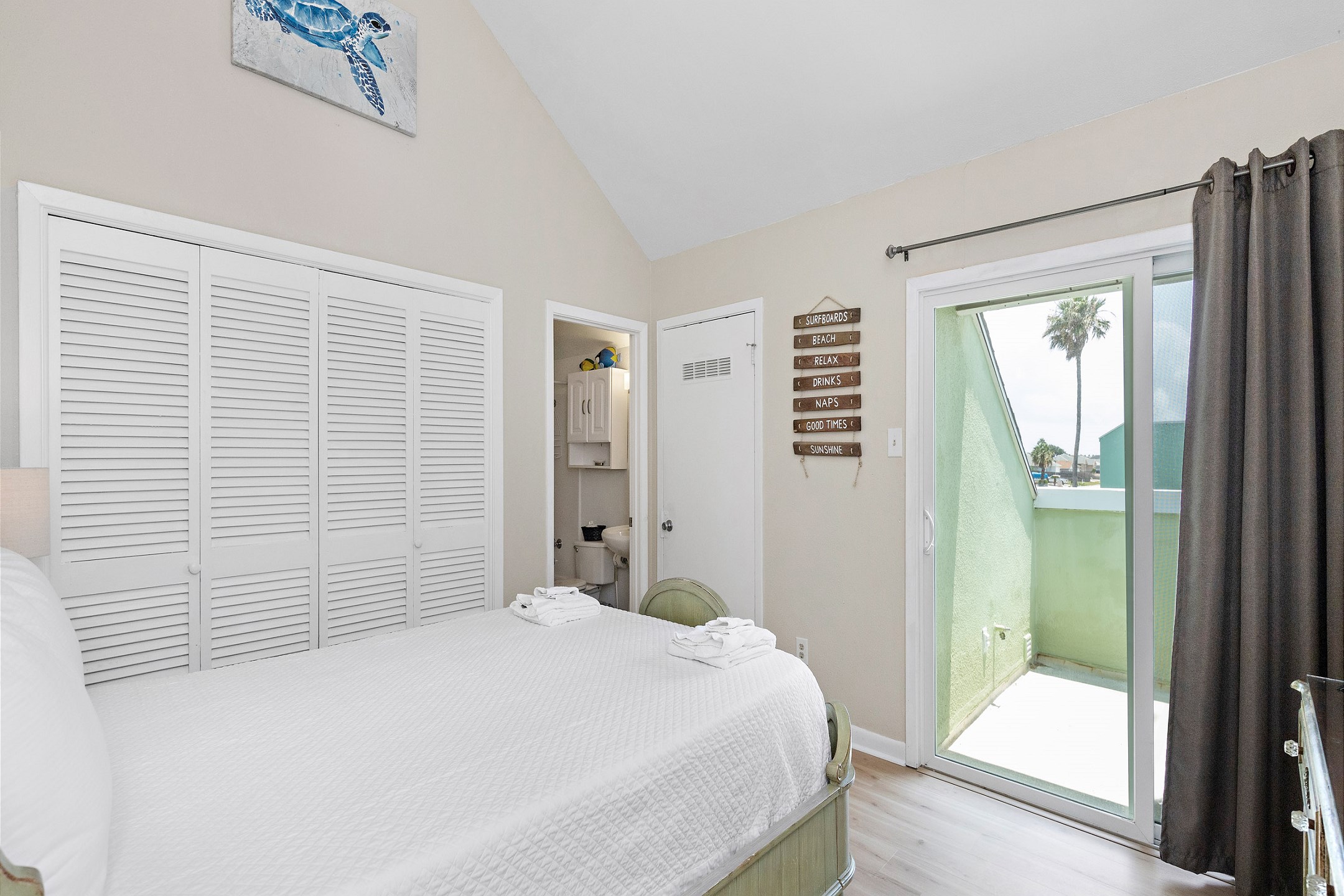 Second bedroom with queen size bed and Tempur-Pedic memory foam mattress topper, along with private balcony