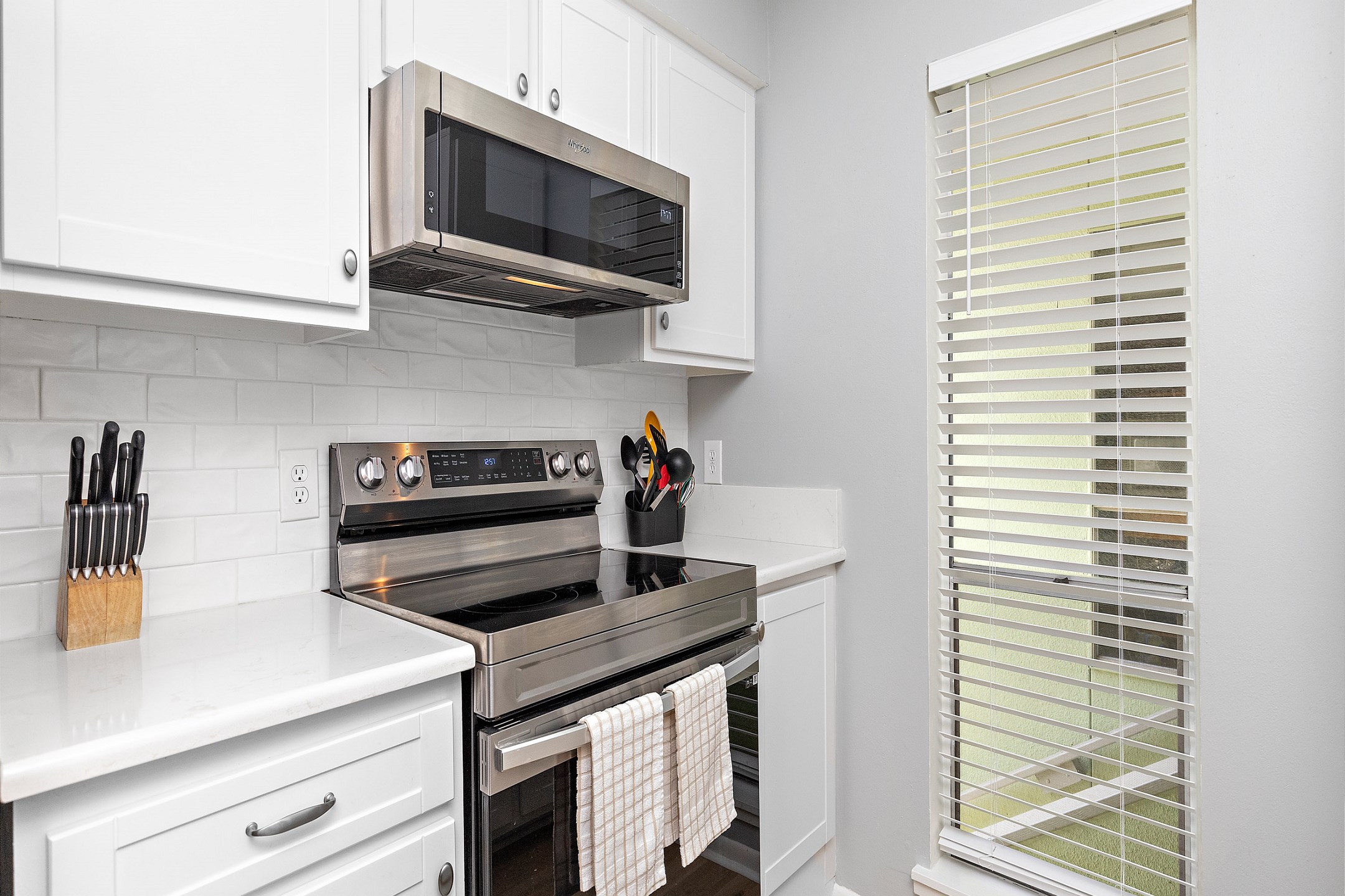 Fully equipped kitchen with stainless steel appliances and ample storage space