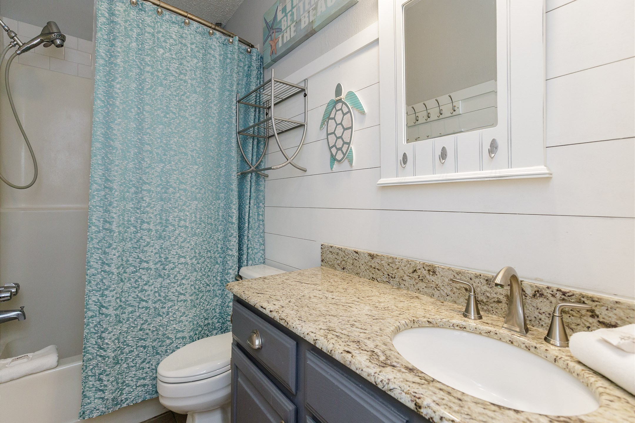 Enjoy the comfort of a newly renovated guest bathroom featuring a tub and shower—perfect for refreshing after a day of sun and sand.