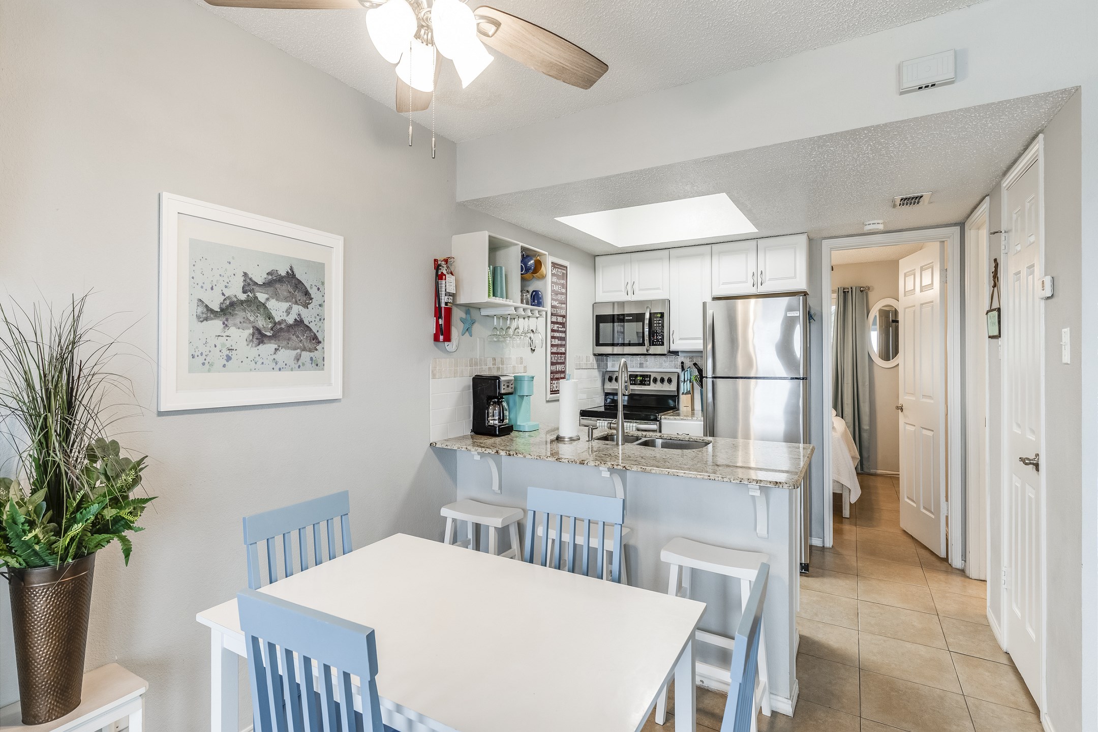 The dining area with seating for four is perfect for family meals, while the breakfast bar with seating for three offers a cozy spot for casual bites or morning coffee.