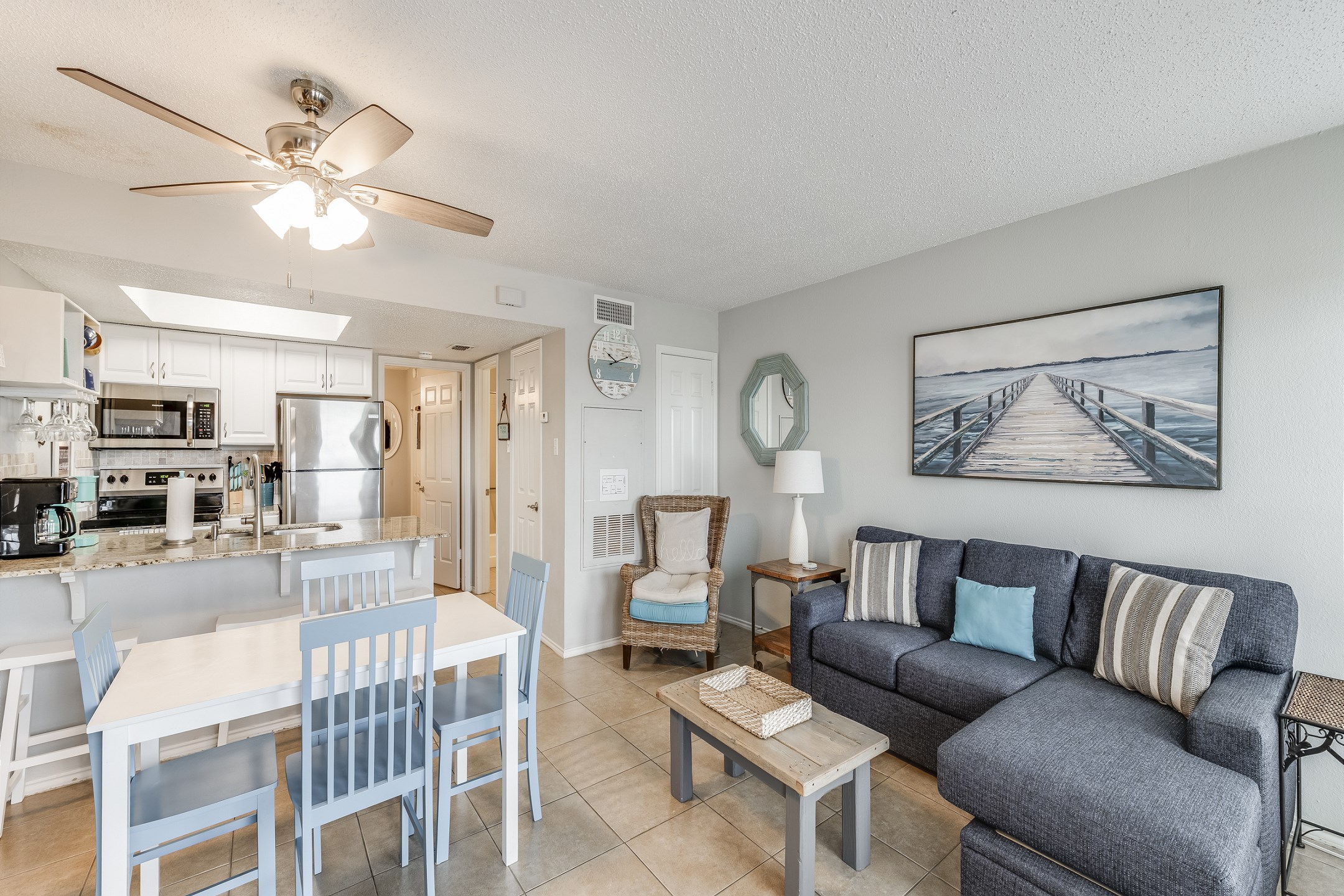 Relax in the sunny living area, decked out with cozy furnishings—perfect for ultimate relaxation and soaking in the laid-back vacation vibes.