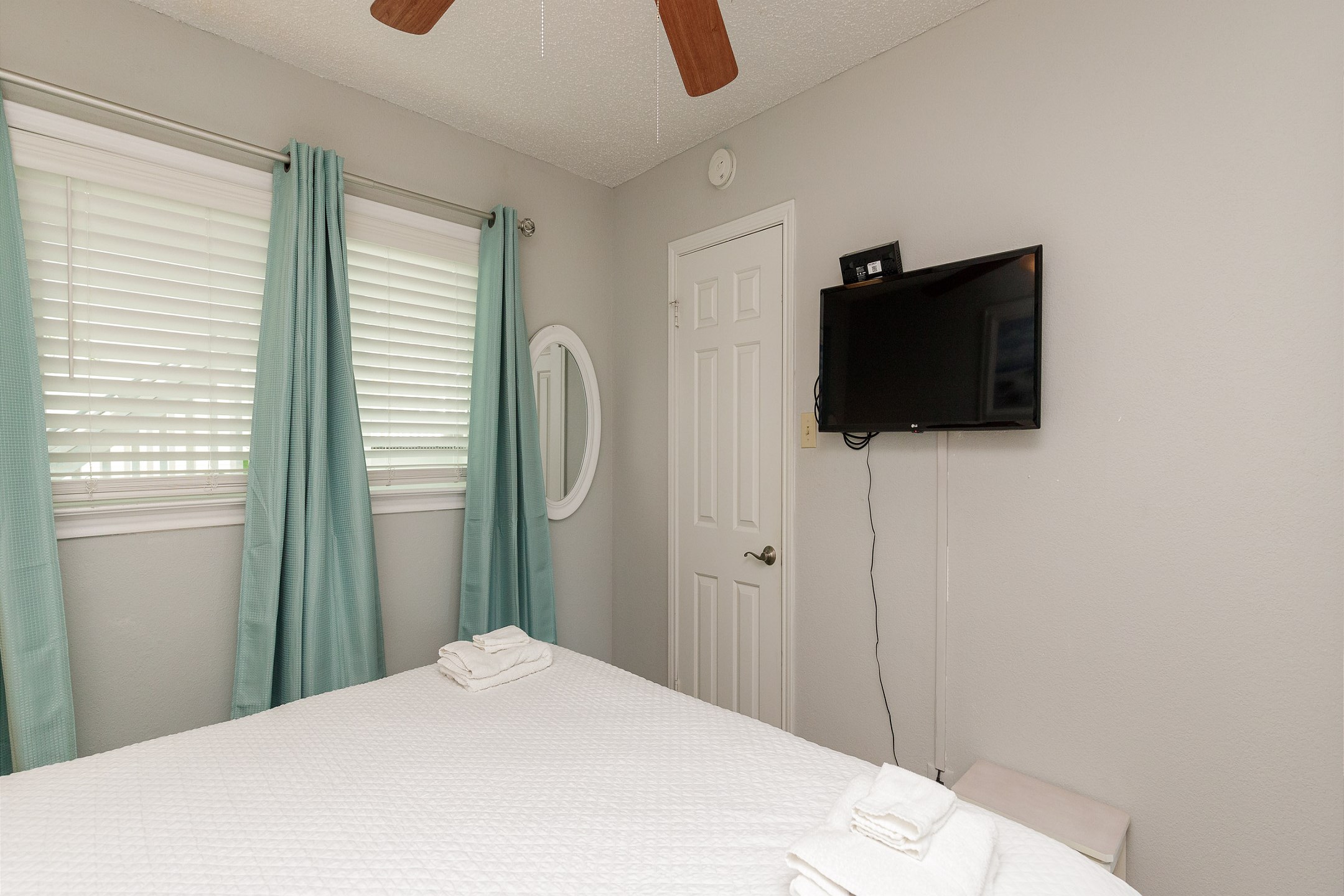 The master bedroom features a king-size bed for ultimate comfort, a dresser for all your storage needs, and a flat-screen TV—making it the perfect retreat after a day of vacation adventures.
