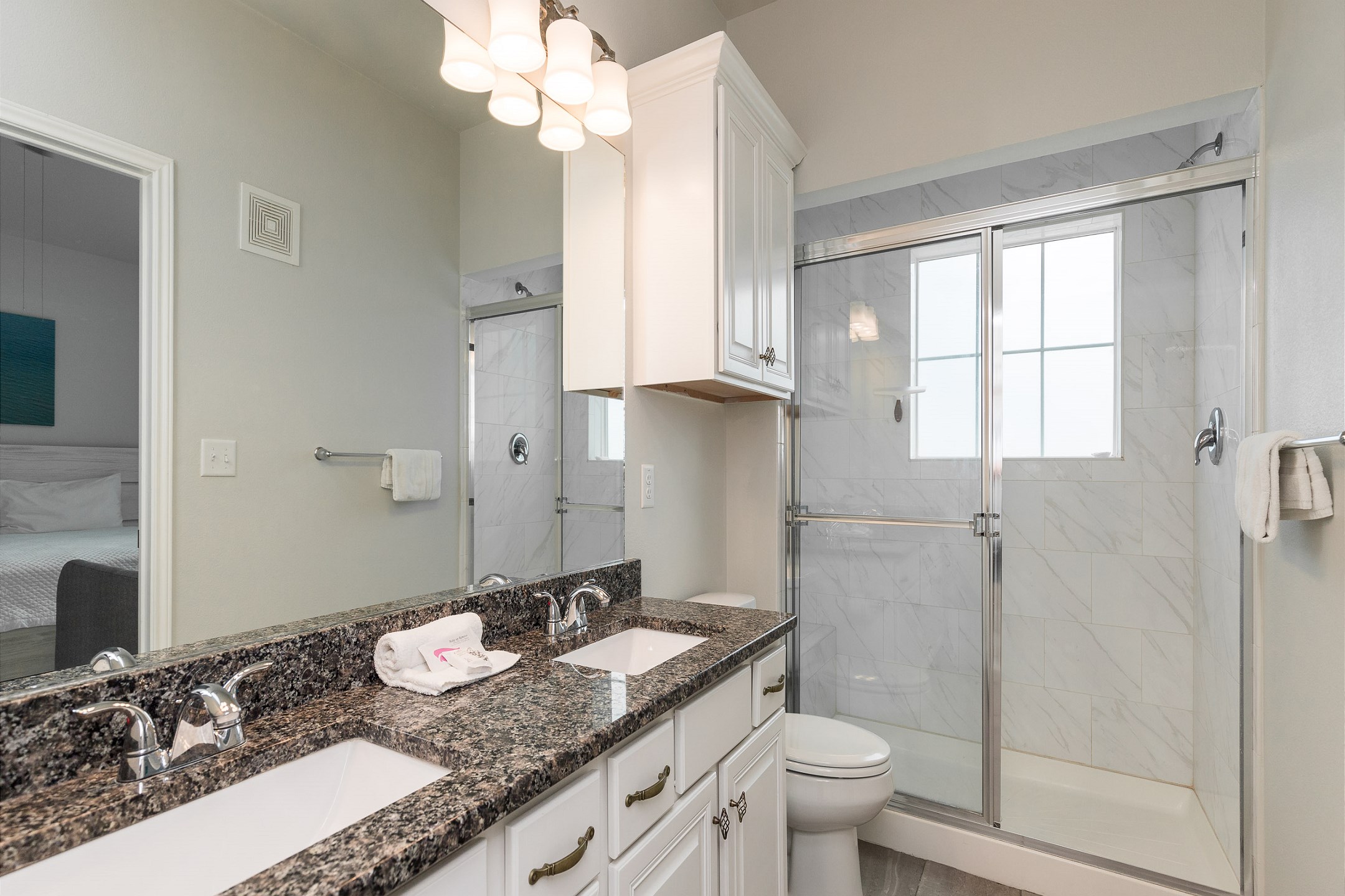 Master bathroom with double sinks and walk in shower 