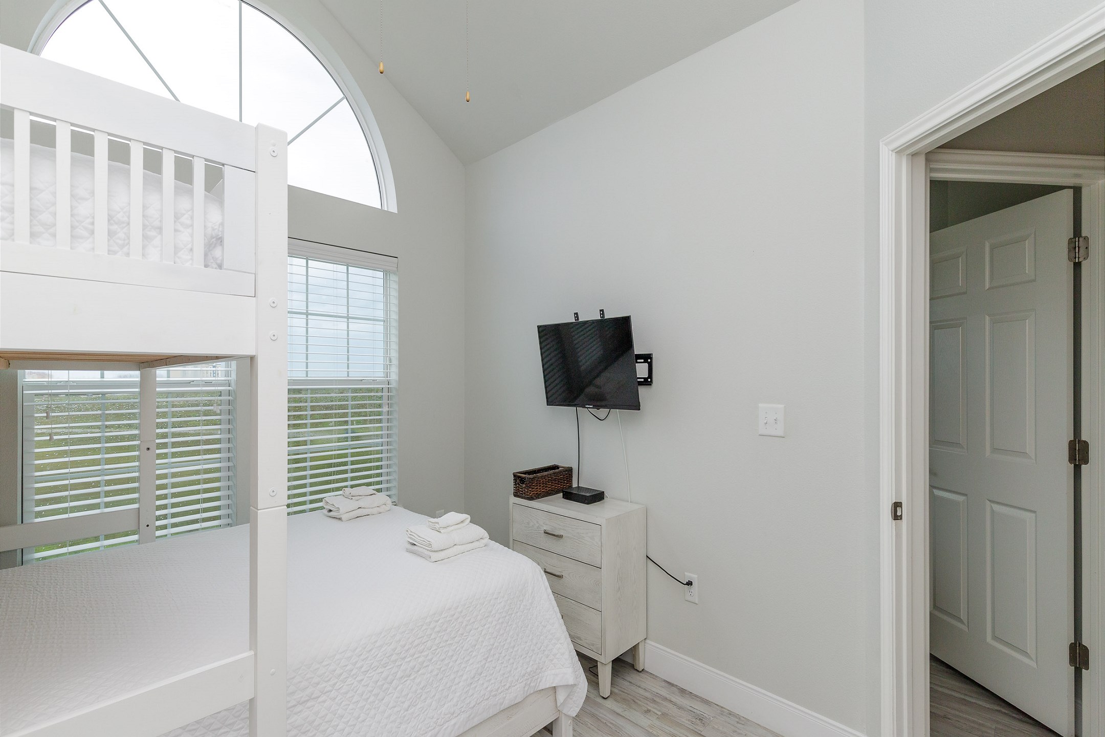 Fourth bedroom on third floor with twin bunk bed over queen size bed and flat screen TV