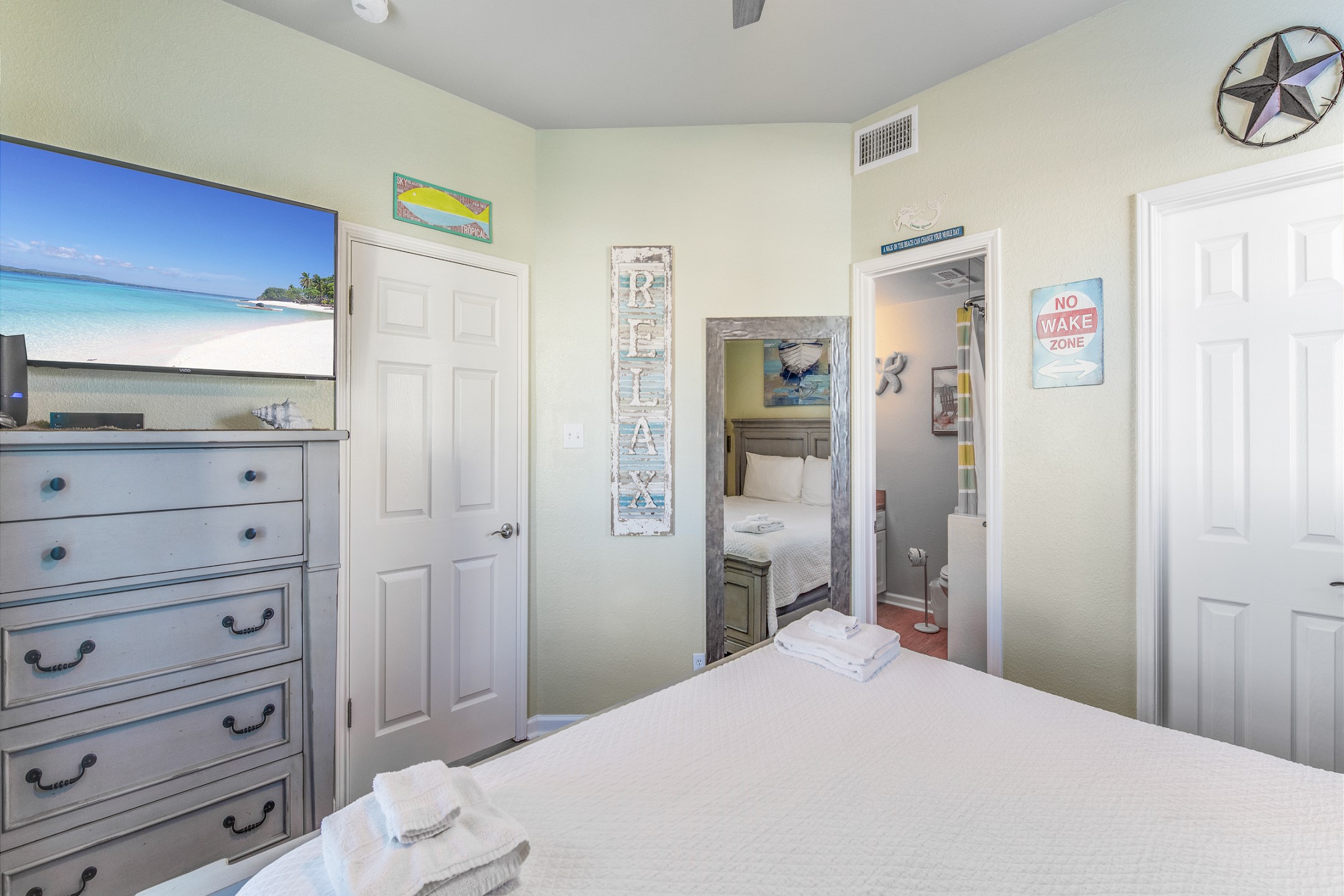 Master bedroom with king size bed and flat screen TV