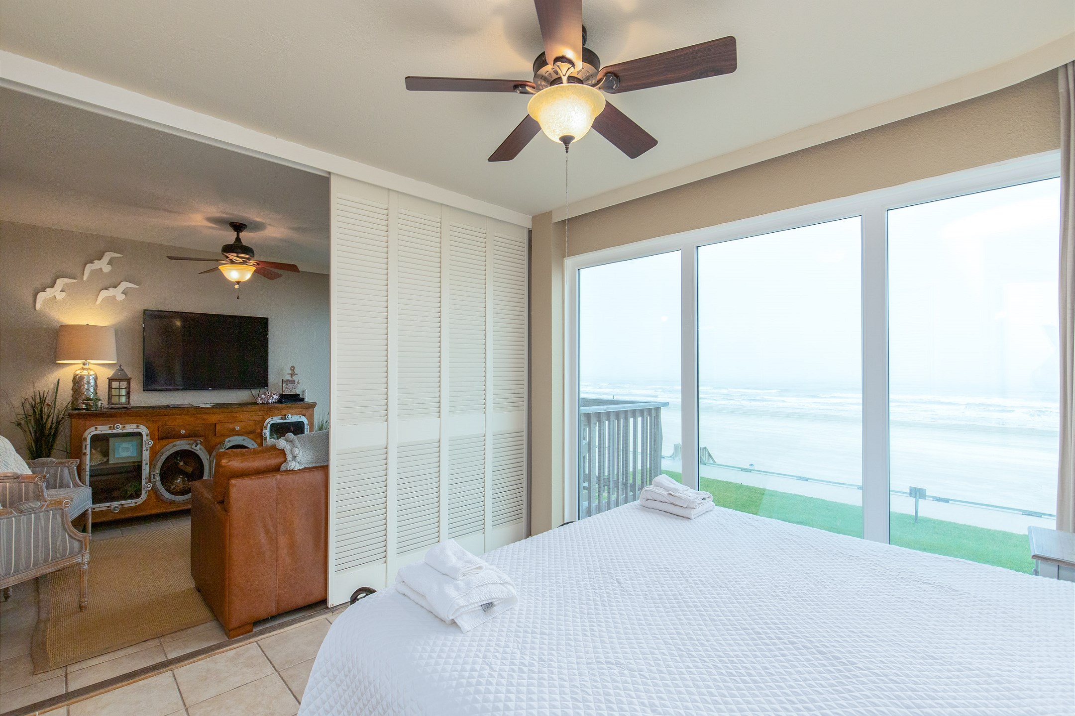 Master bedroom with king size bed, private bathroom, and views of the beach 