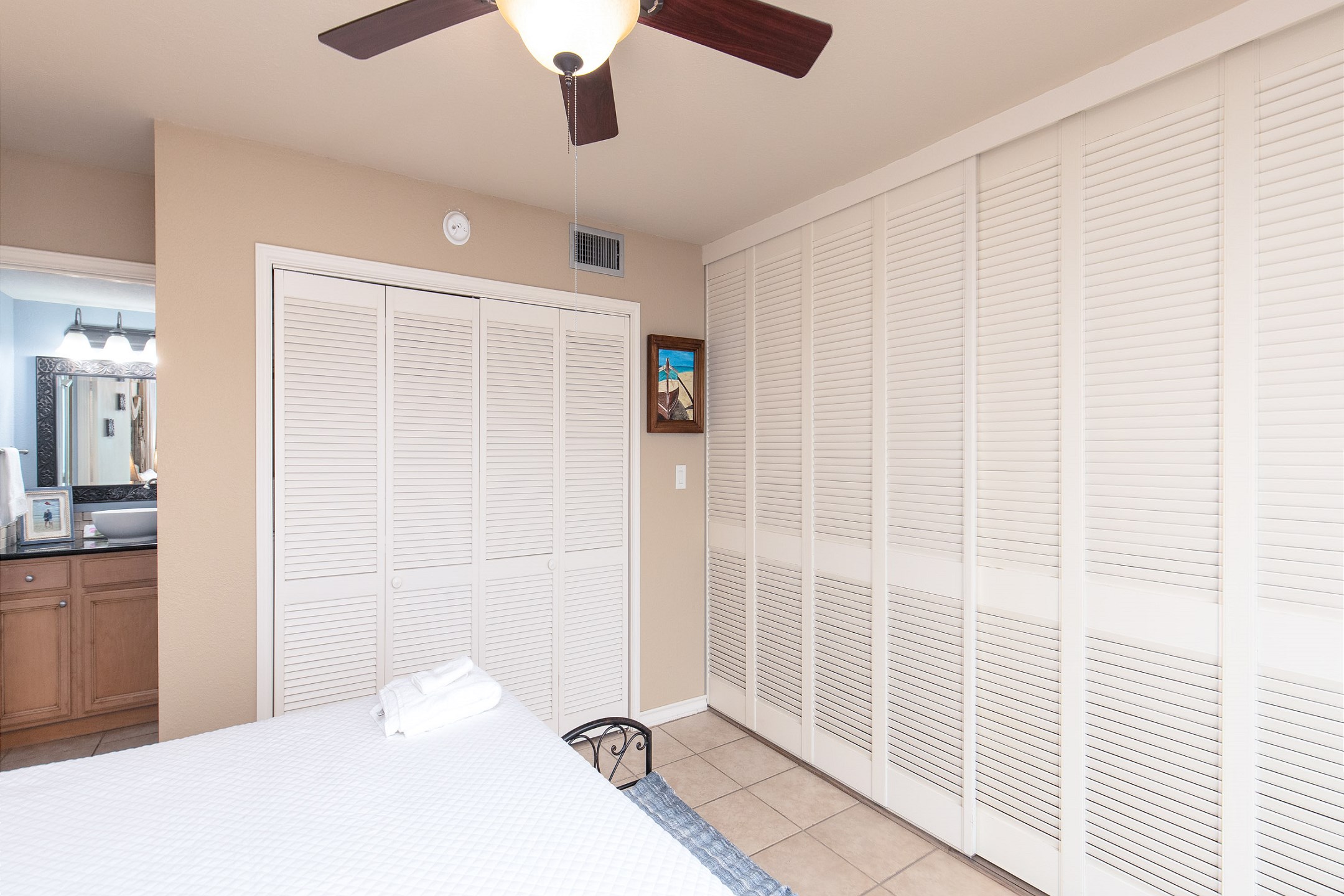 Master bedroom with king size bed, private bathroom and shutters that close for privacy