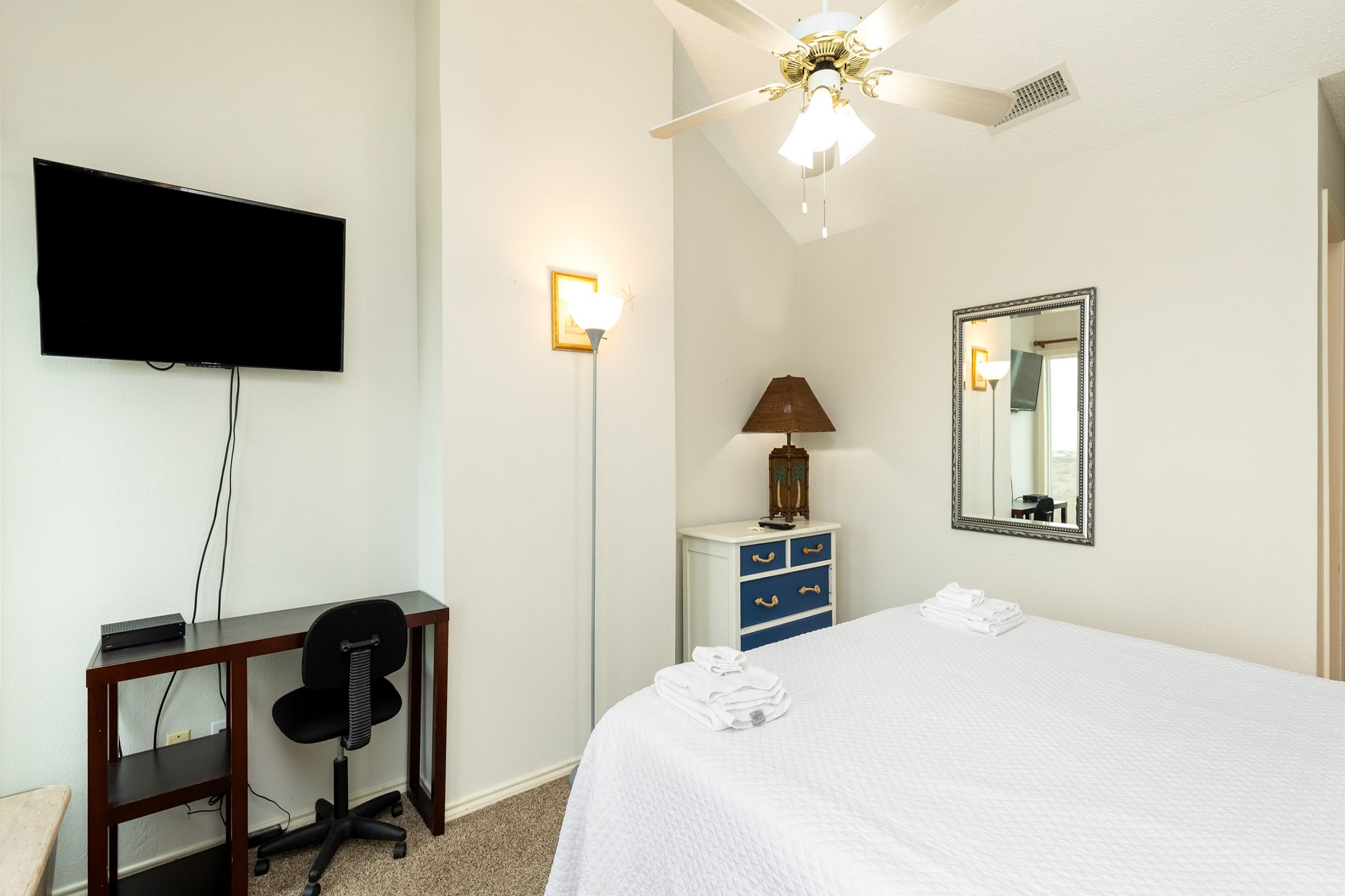 Master bedroom on the second bedroom with a king size bed, ensuite bathroom, private balcony, and flat screen TV