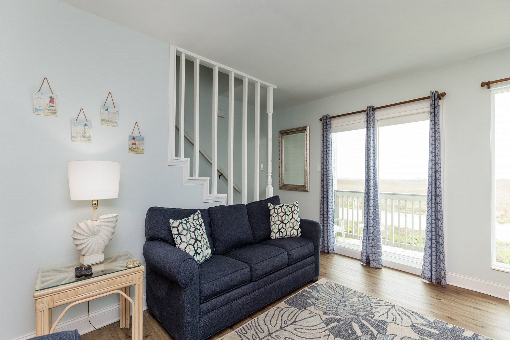 Living area with full size sleeper sofa and a private balcony 