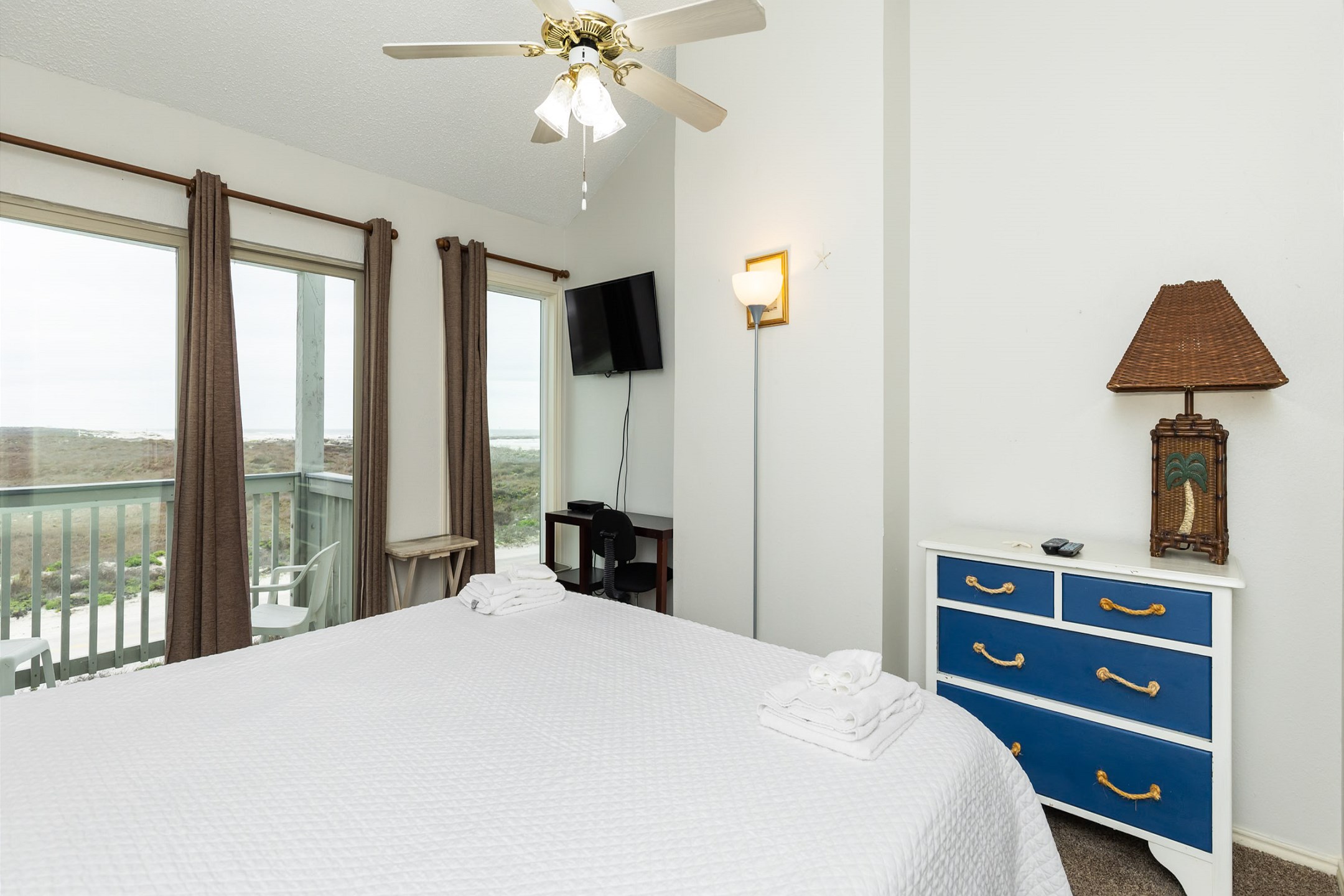 Master bedroom on the second bedroom with a king size bed, ensuite bathroom, private balcony, and flat screen TV