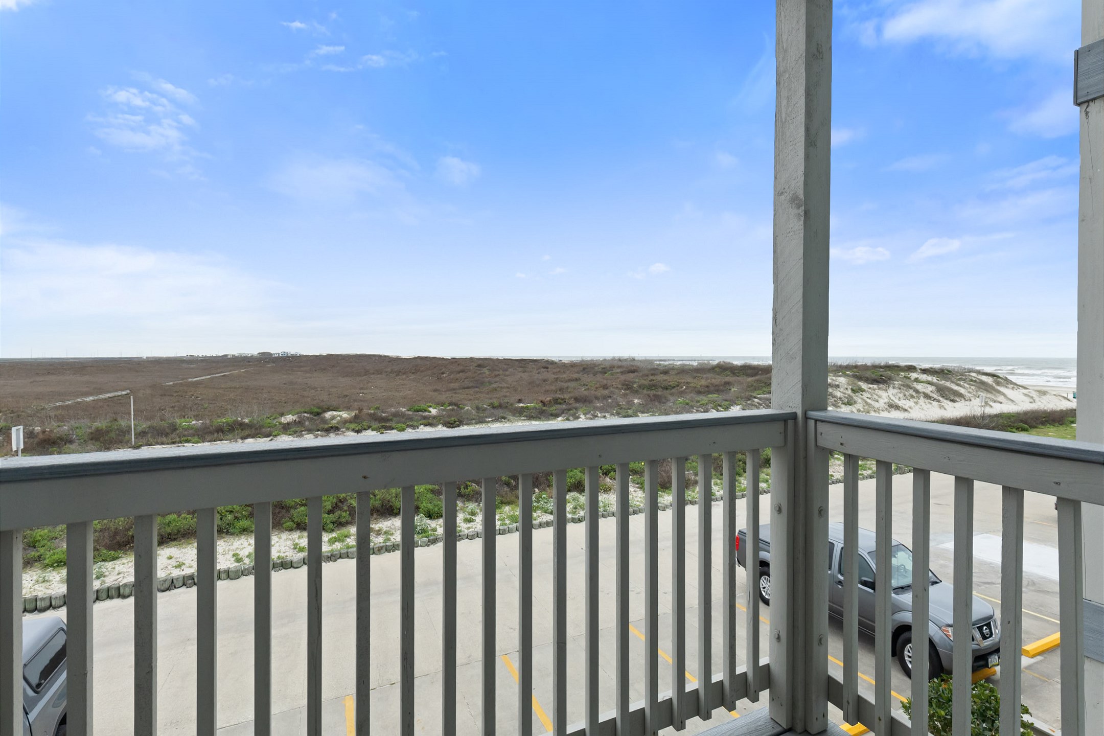 Private balcony off the living area with a view of the coastal dunes, the beach, and Gulf of Mexico