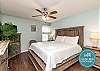 Beautifully furnished master bedroom featuring a king size bed, full sized dresser, nightstand, and chest with a flat screen tv.