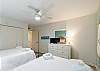 Second bedroom with two full size beds and flat screen TV