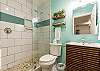 Newly updated bathroom with walk in shower, storage cabinet, paint and décor
