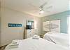 Second bedroom with two full size beds and flat screen TV