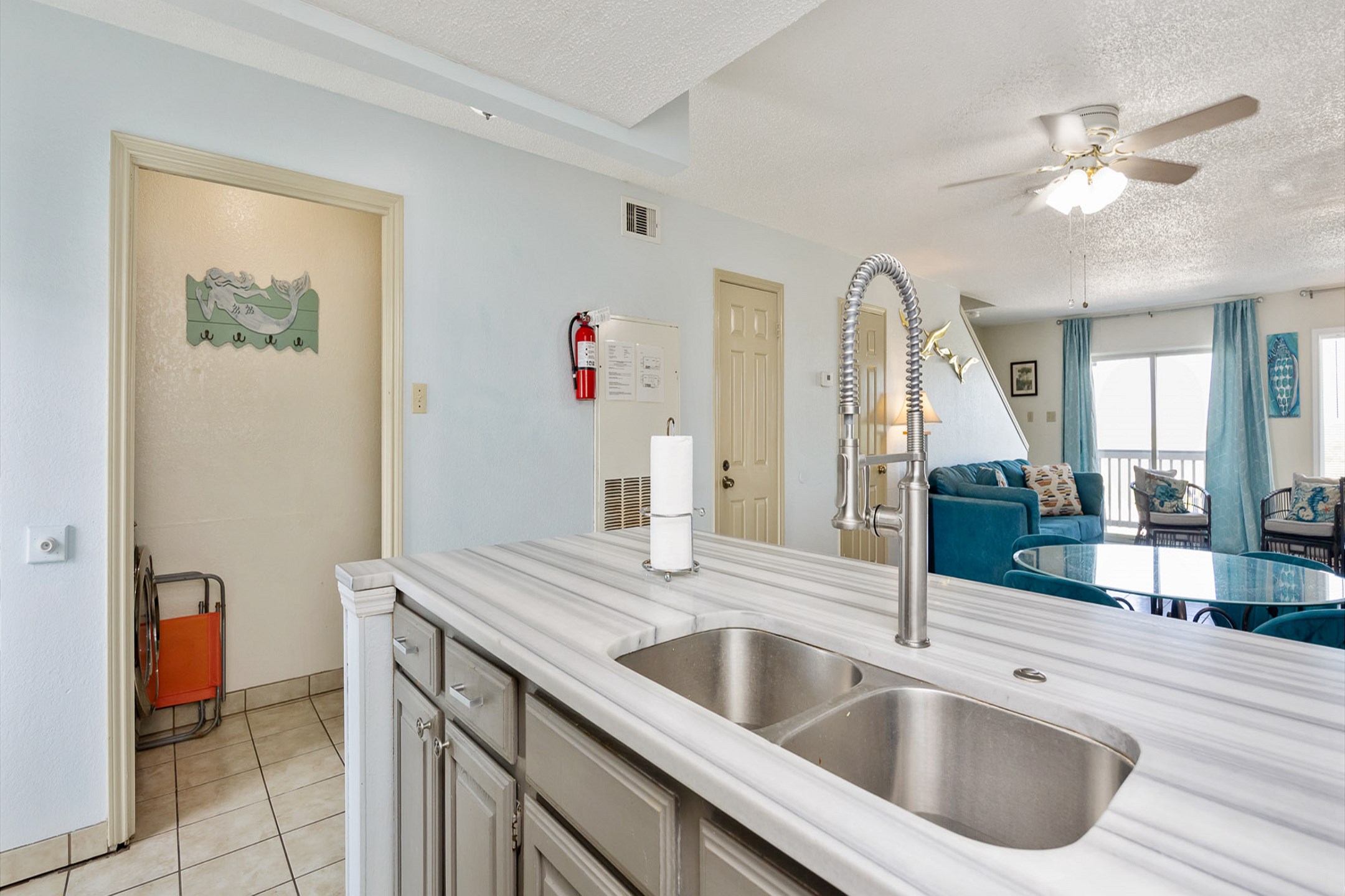 Kitchen looks into open concept living and dining area 