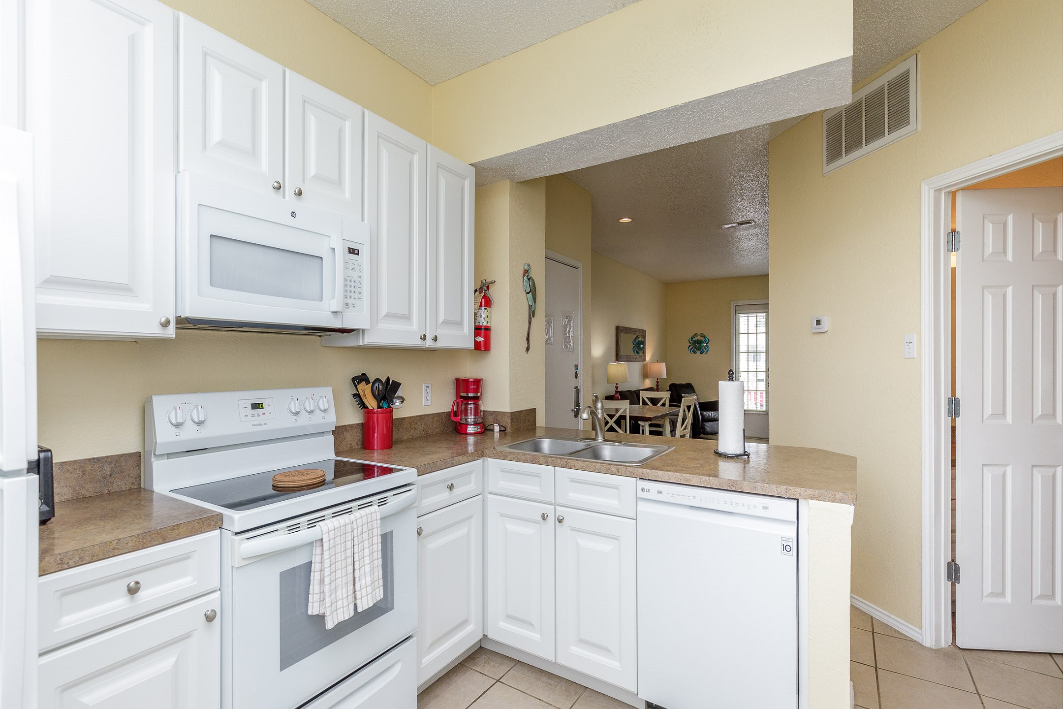 Coffee maker, toaster, cookware, dinnerware, and other kitchen essentials provided