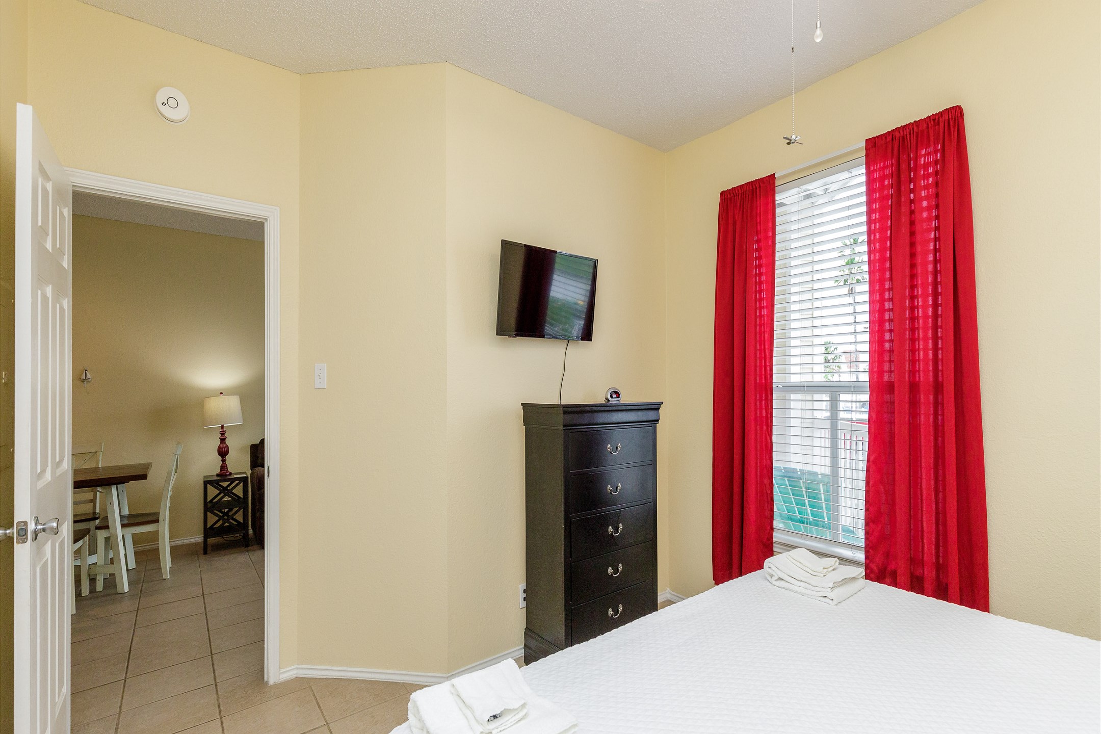 Master bedroom with king size bed, private bathroom, and TV