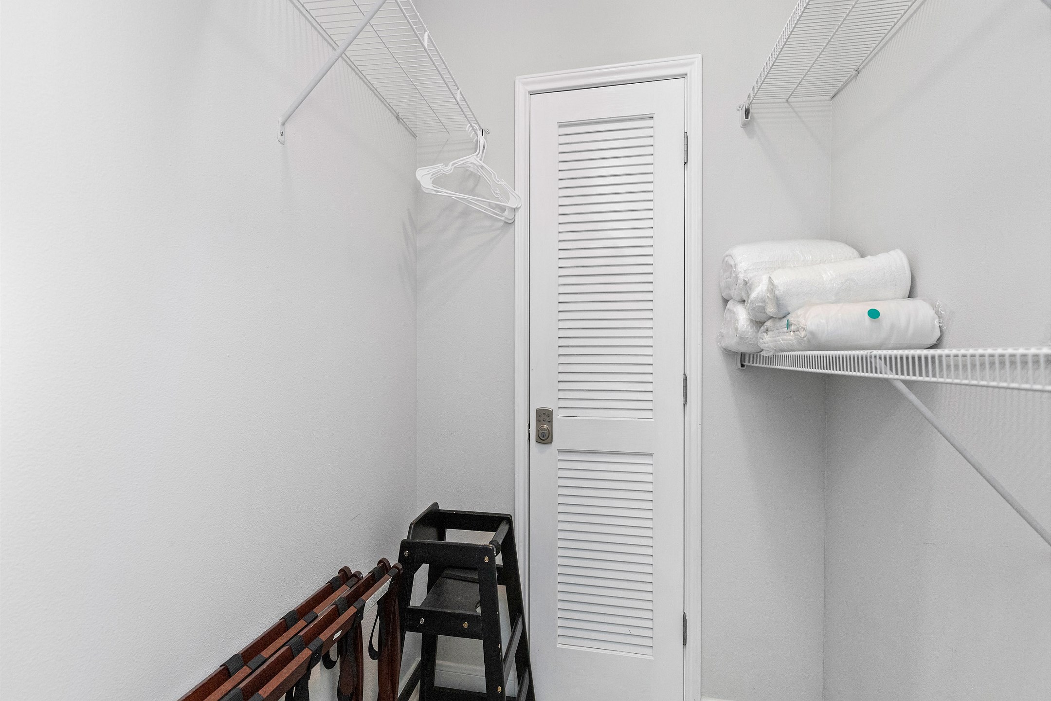 Master bedroom walk in closet with highchair 