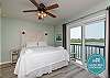 Master bedroom with king size bed and private balcony with a view of the canal