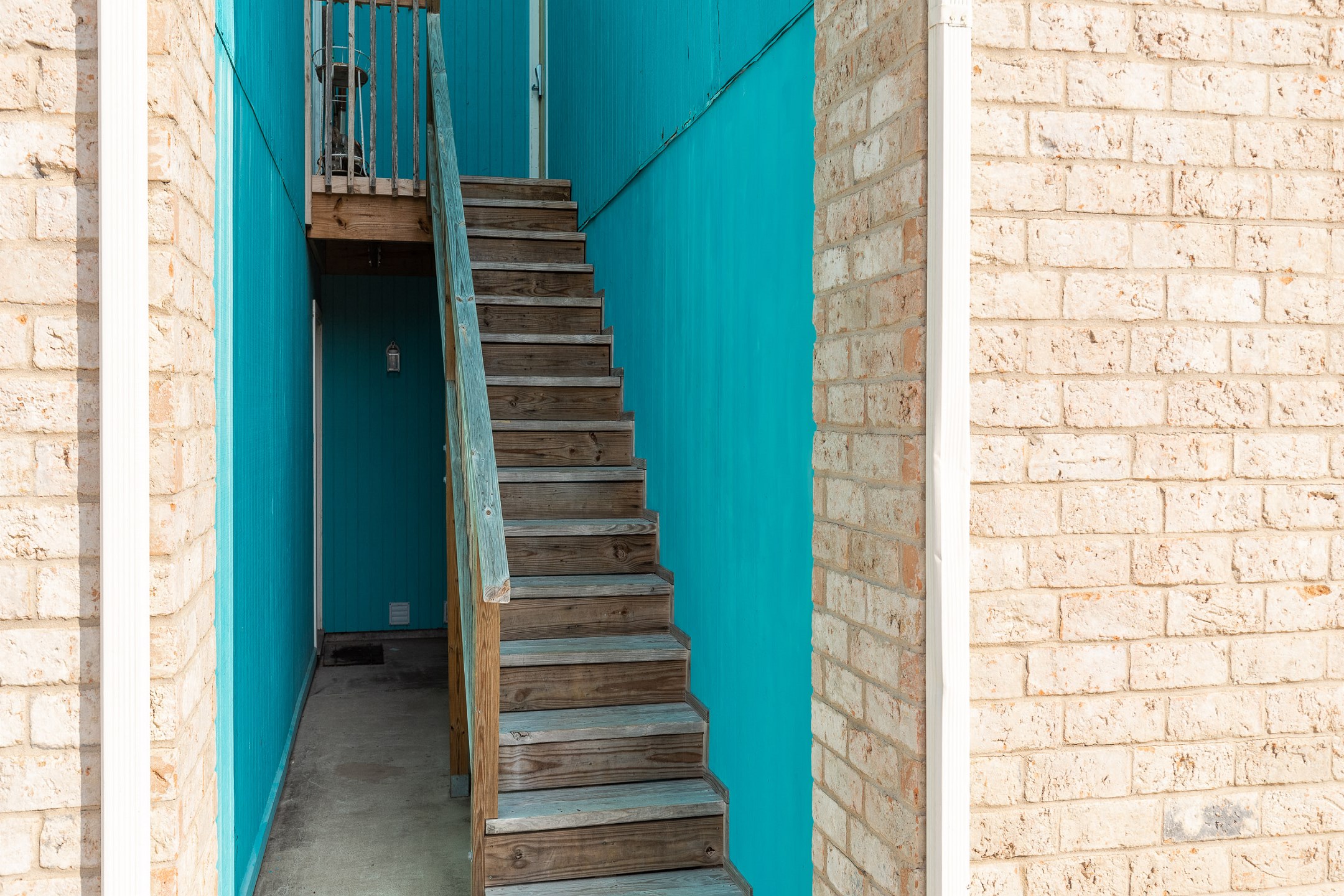 Stairs leading to second floor, front entrance condo