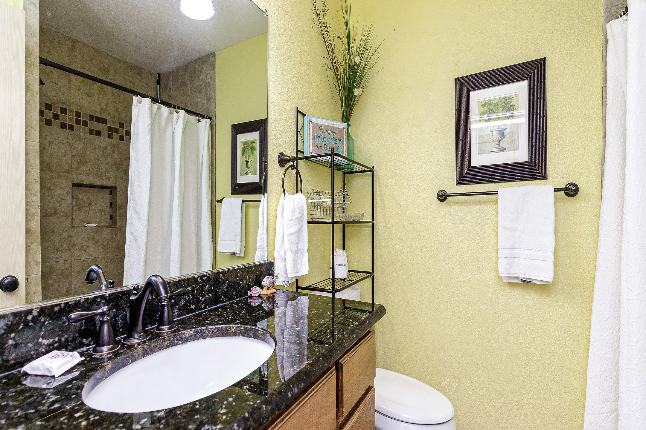 Guest bathroom with tiled low threshold walk in shower 