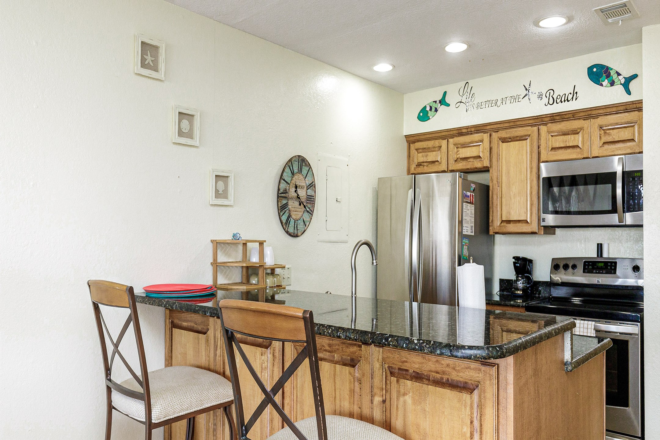 Fully equipped kitchen with breakfast bar that seats two