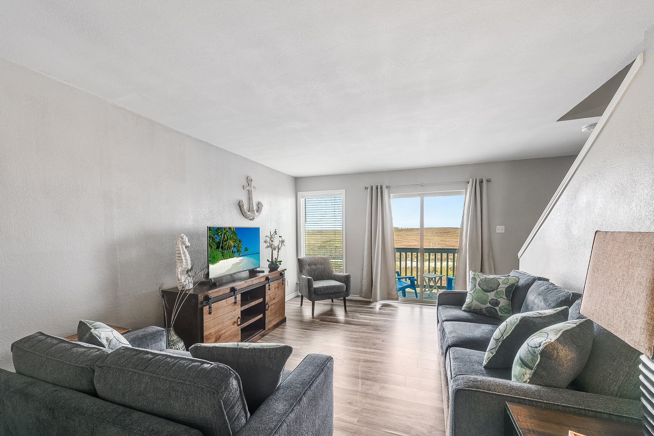 Spacious living area with plush seating, including a queen sleeper sofa, and a flat-screen TV for entertainment