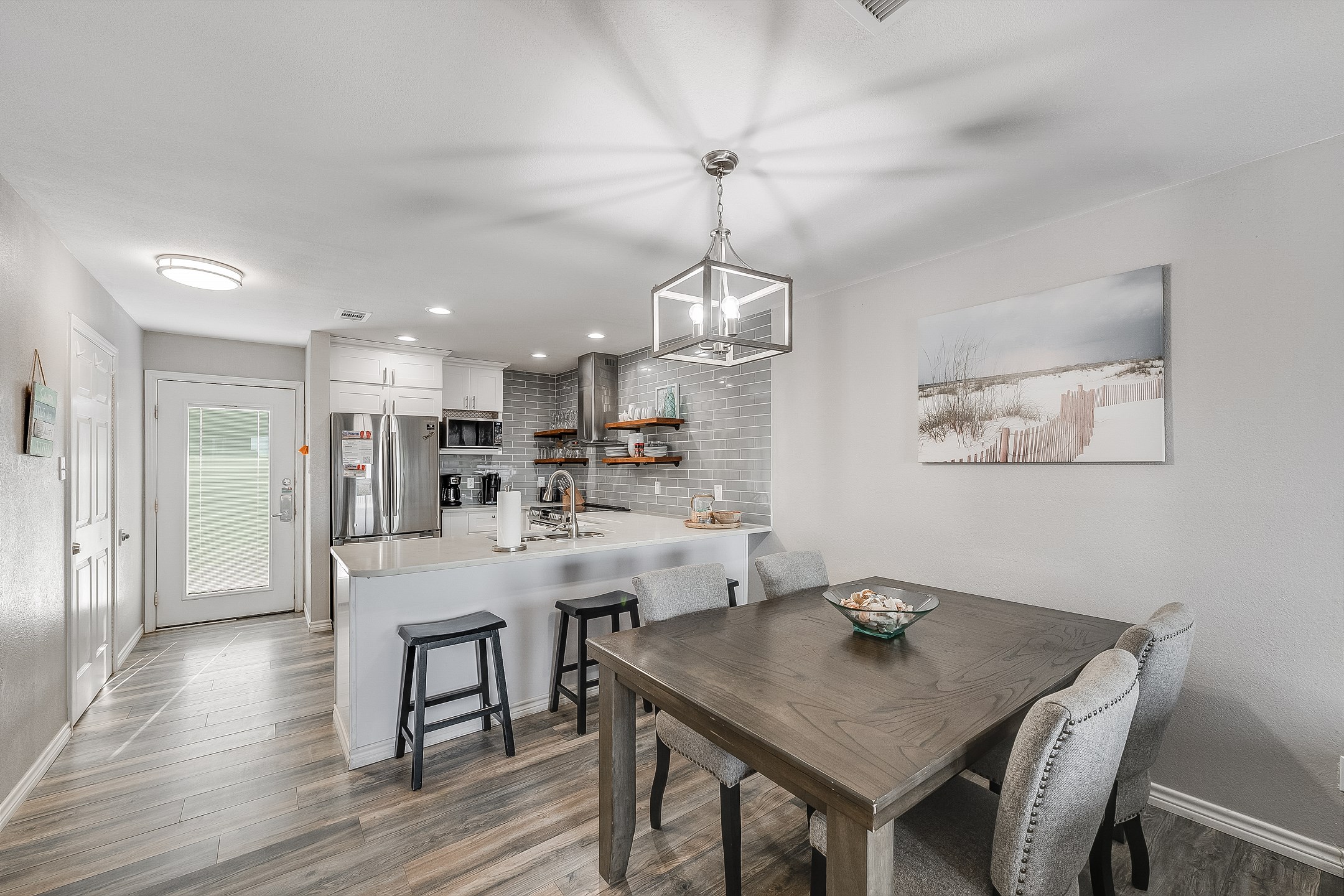 Sleek modern kitchen boasting granite countertops and ample space for preparing a full meal