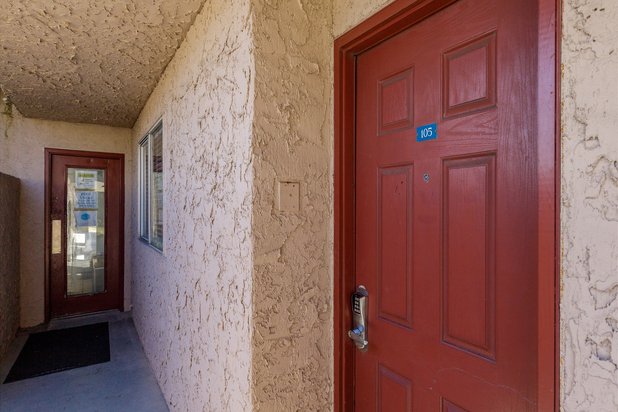 Front door entrance to condo #105 with coded lock for extra security 