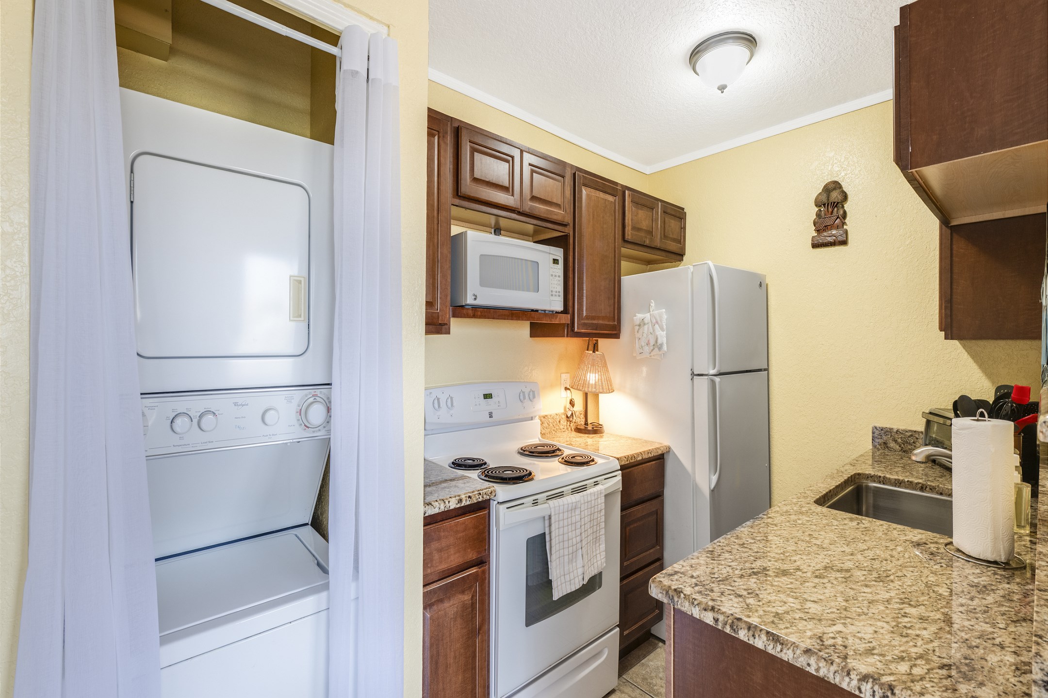 Kitchen comes with modern appliances including a Keurig coffee maker