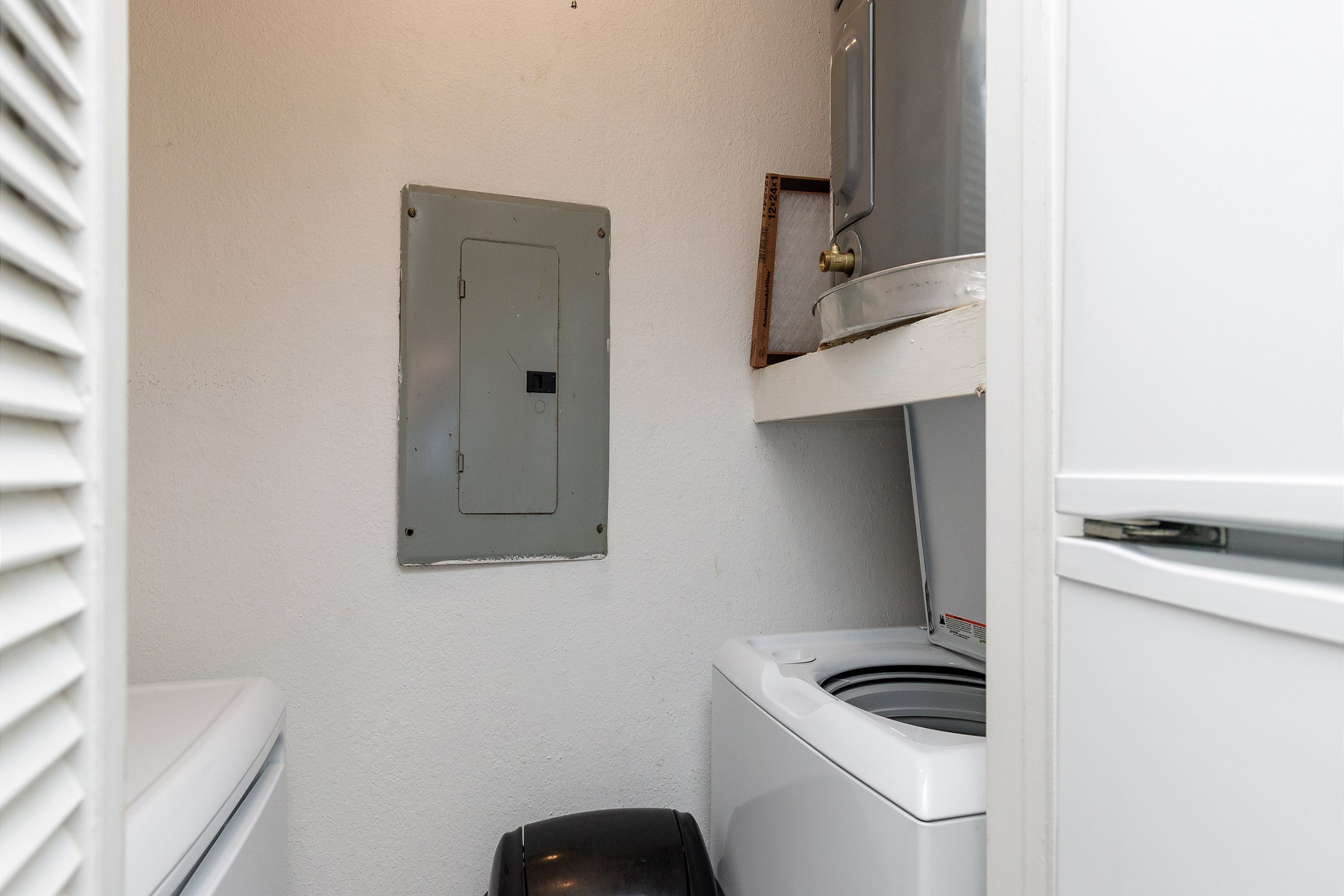 Washer and dryer in condo next to kitchen 