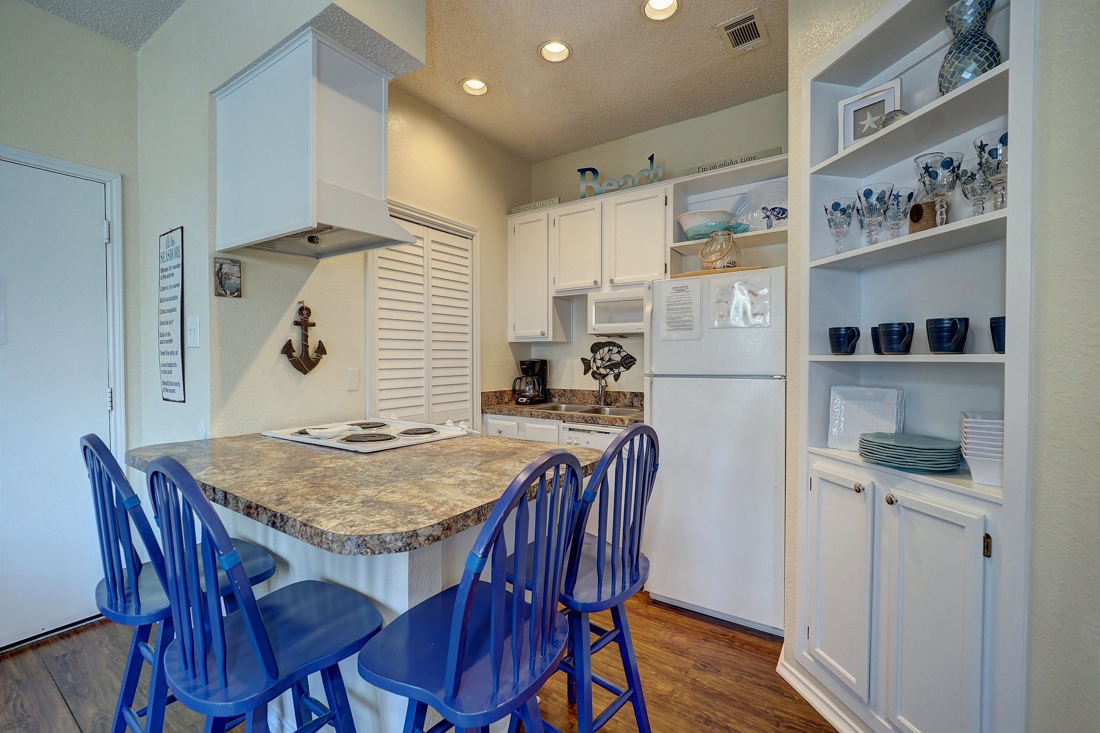 Fully equipped kitchen area with seating for four at the breakfast bar