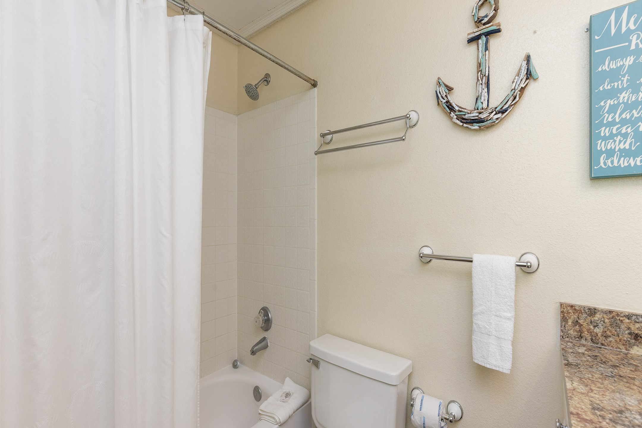 Guest bathroom with large counter tops and tub/shower combo
