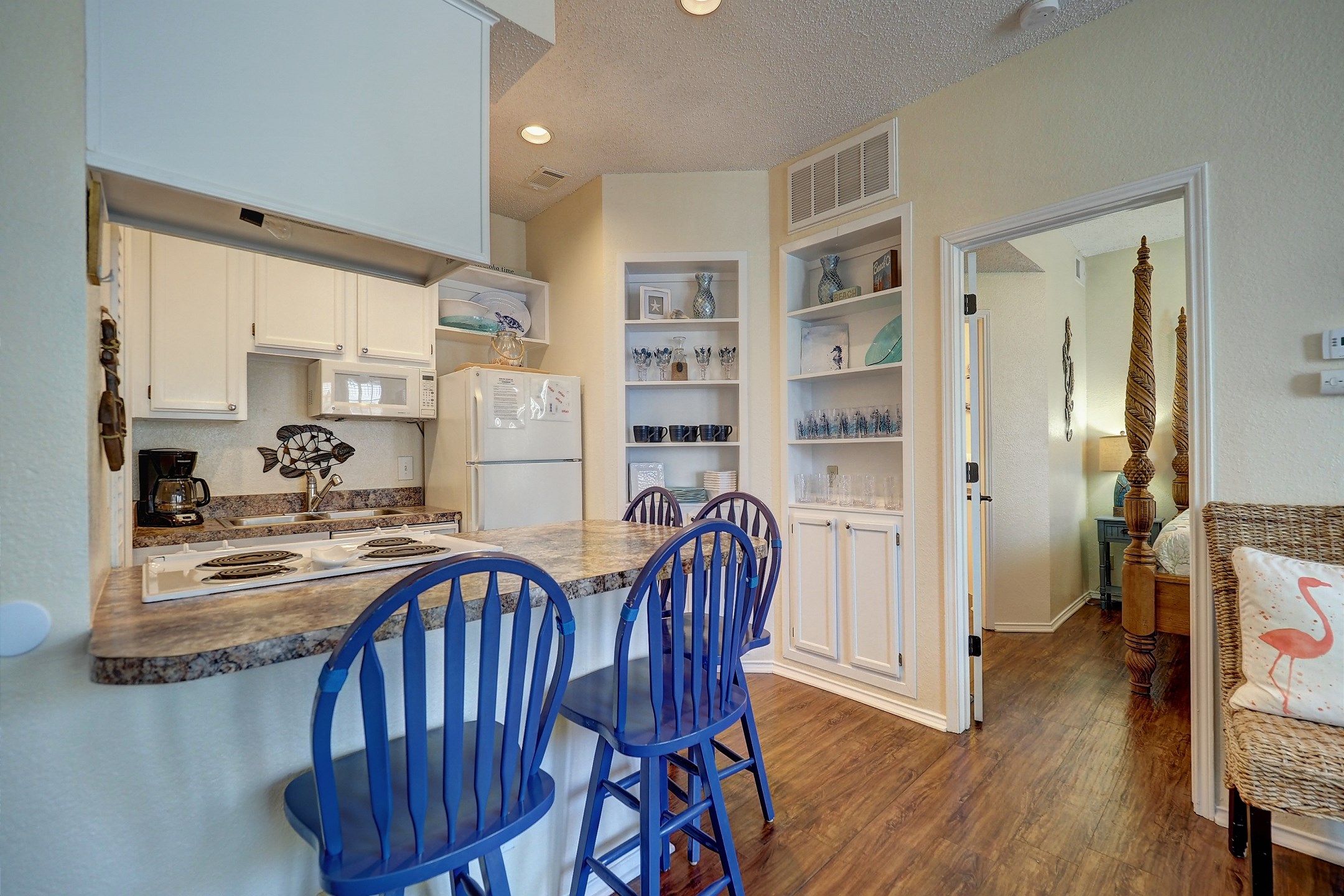 Fully equipped kitchen area with seating for four at the breakfast bar