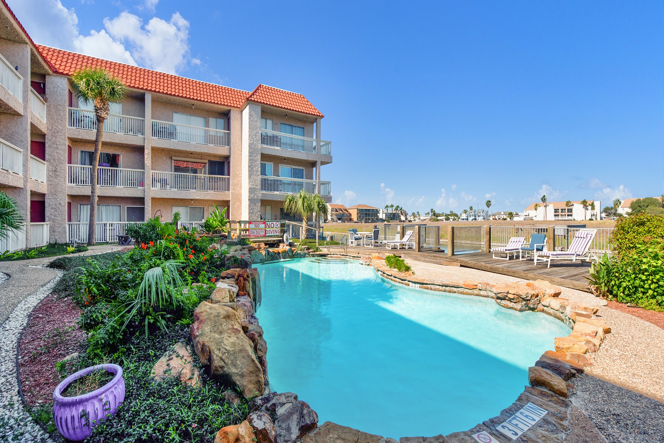 Indulge the canal, water views at Mystic Harbor pool with relaxing loungers