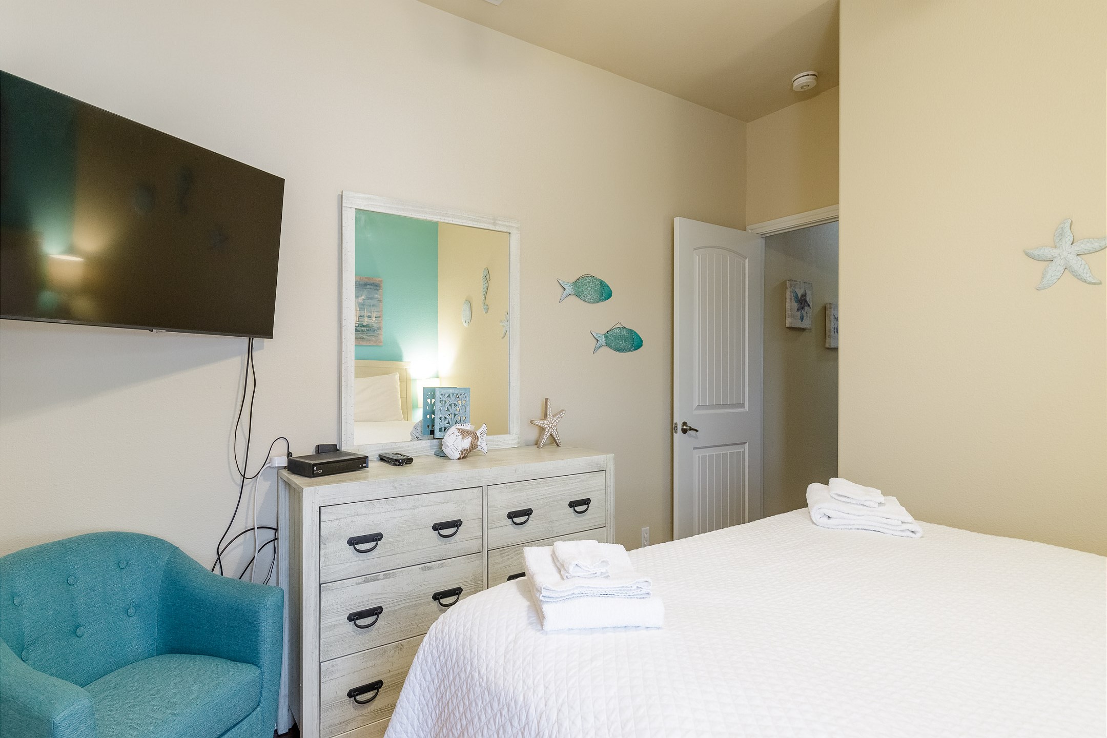 Updated master bedroom with king size bed, new furniture, and private bathroom 