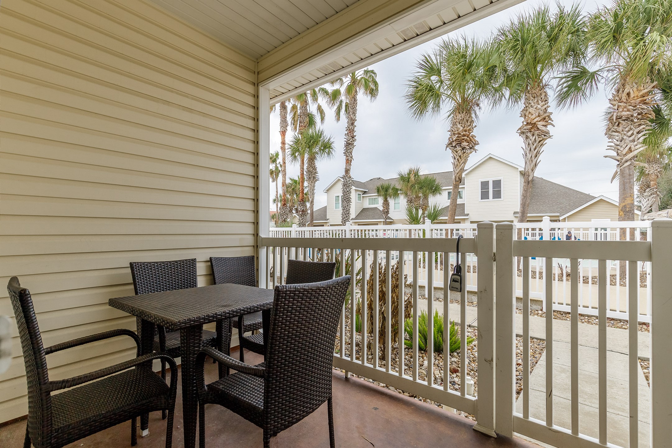 Private patio area with table and chairs that over looks the pool