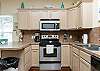 Fully equipped kitchen with stainless steel appliances and plenty of counter space to cook meals with the family 