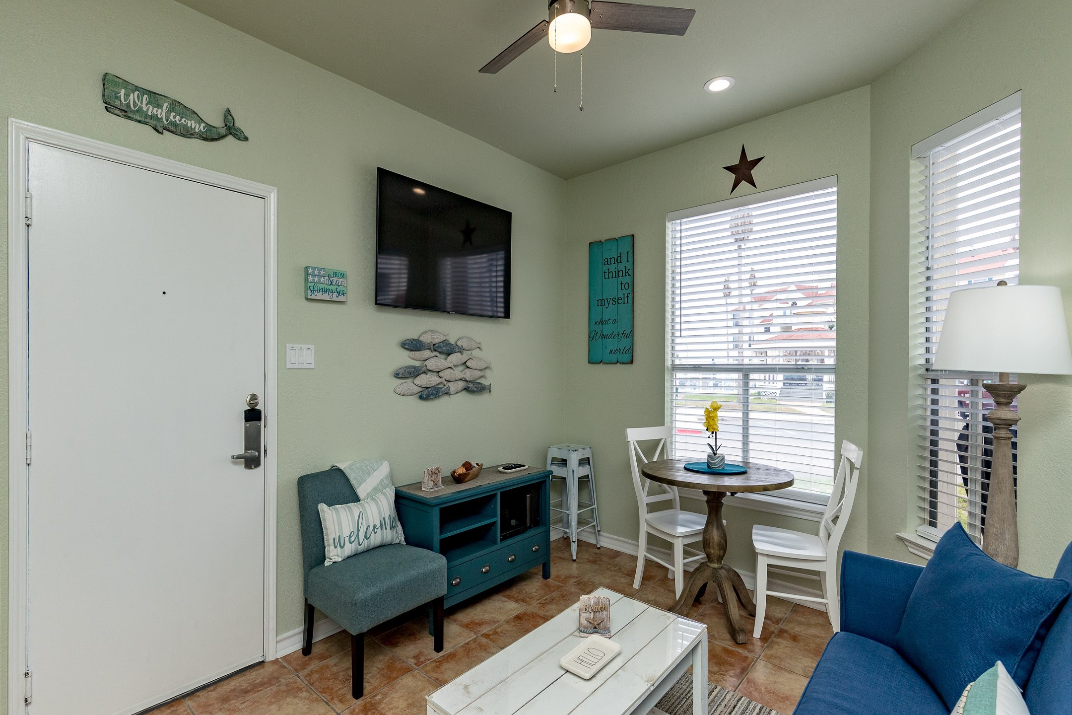 Open concept living area with queen size sleeper sofa and flat screen TV 