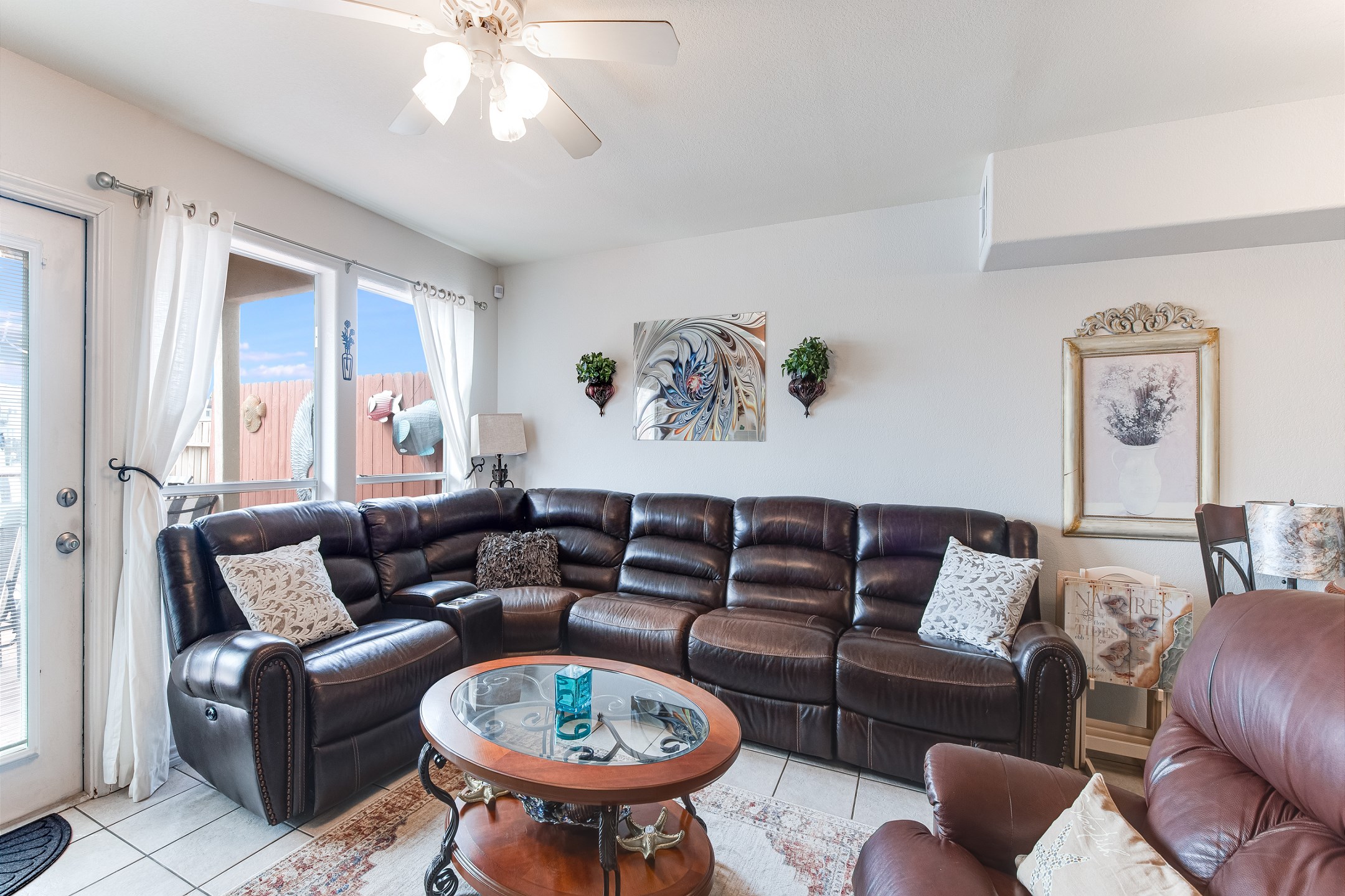 Newly updated living space with a large sectional offering three recliners