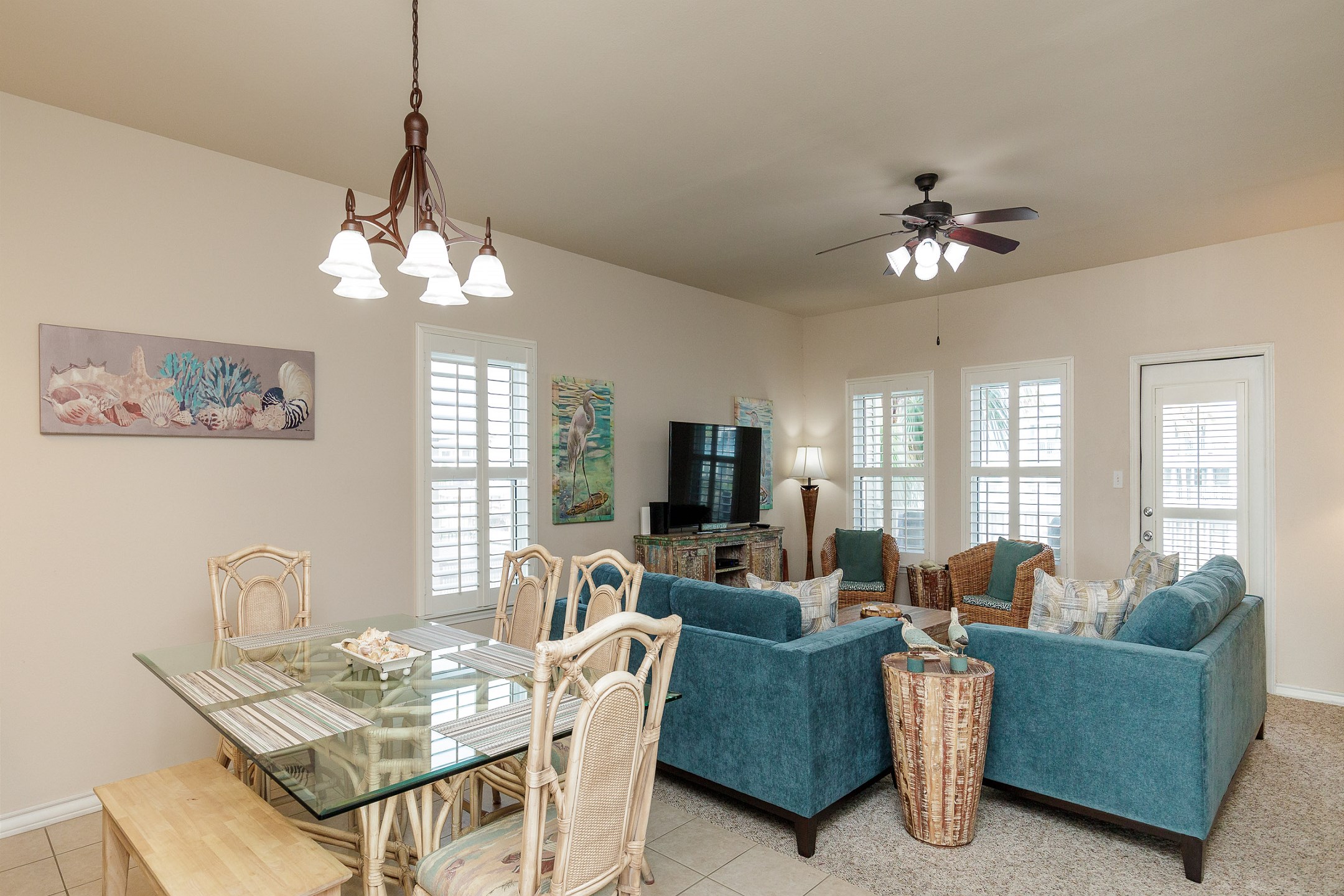 Open concept living and dining space with large windows 