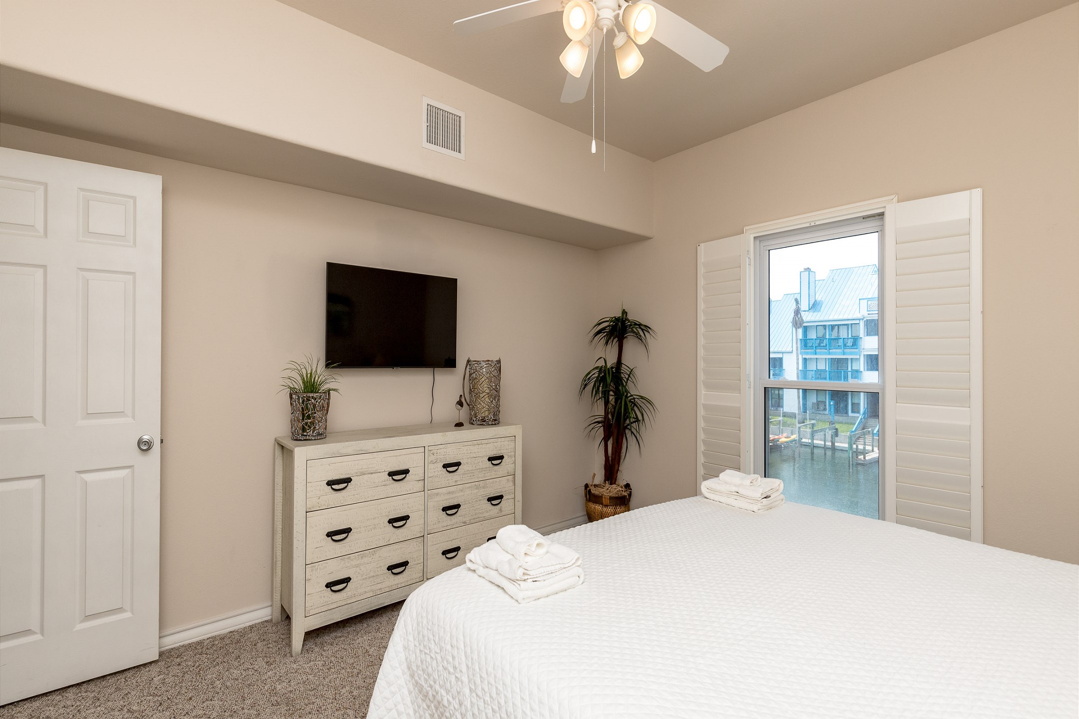 Master bedroom with a king size bed, private bathroom and a view of the canal