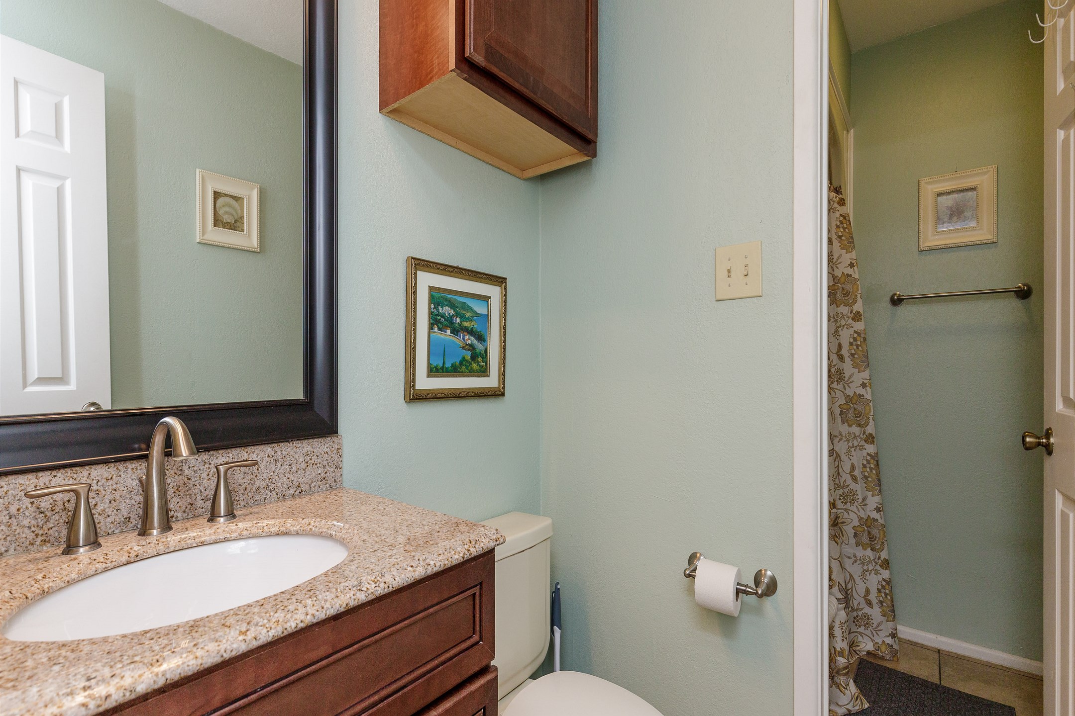 Guest bathroom with toilet, sink, and tub/shower combo